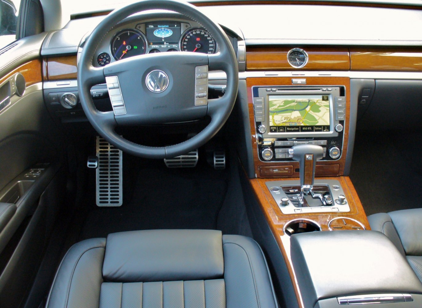Luxury car interior with navigation system and wood trim