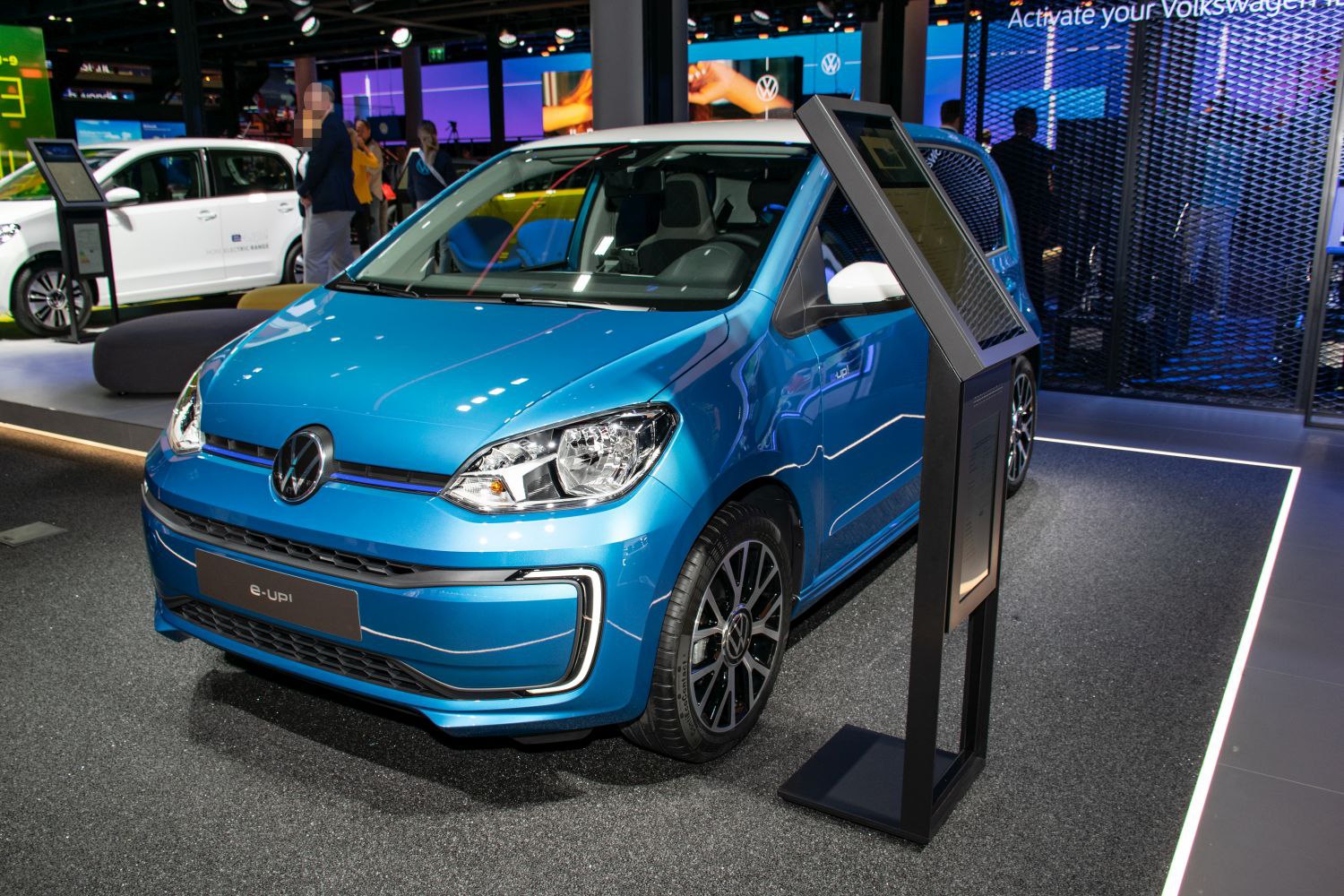 Blue electric city car with LED headlights and modern design
