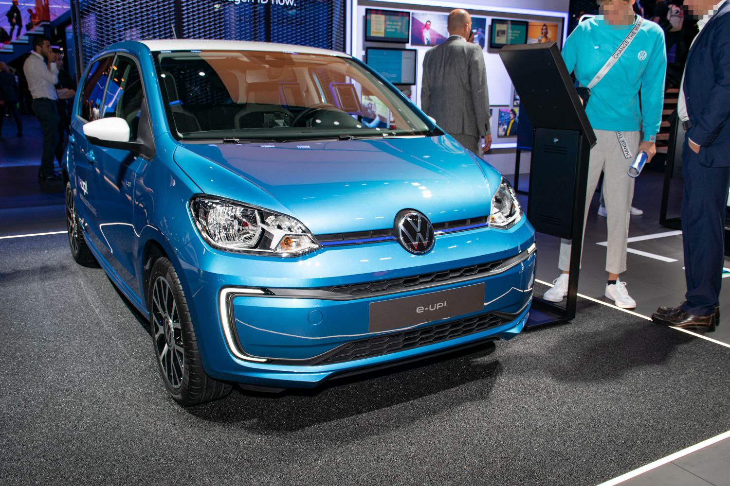 Front view of blue compact electric vehicle with modern headlights and grille