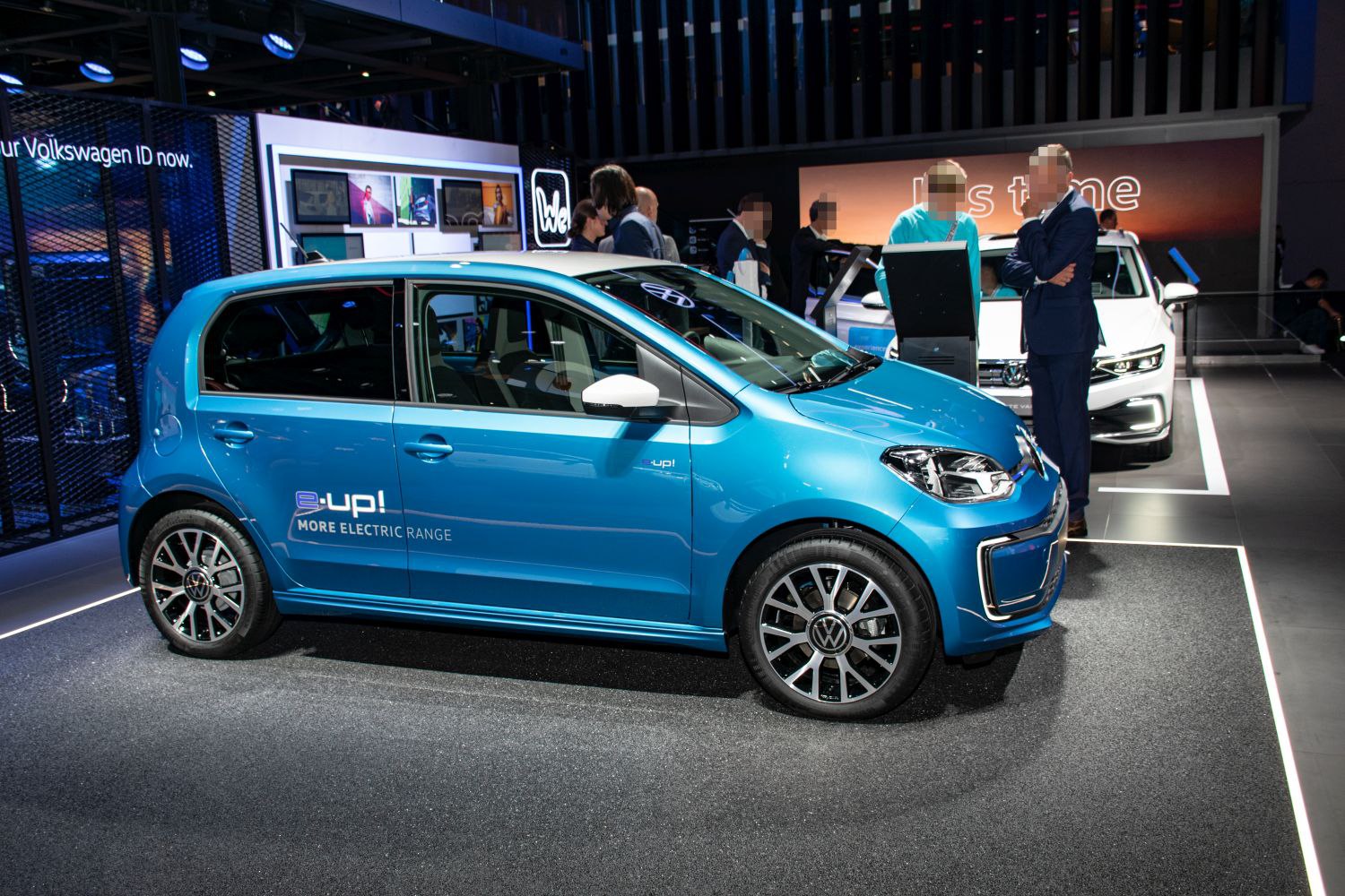 Side view of electric vehicle with alloy wheels and blue paint