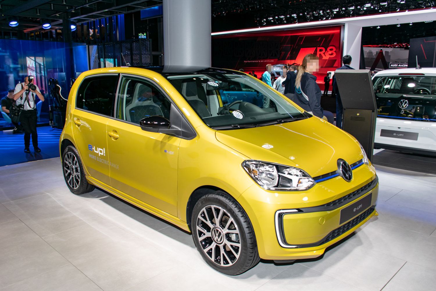 Yellow compact electric car with facelift front design and alloy wheels