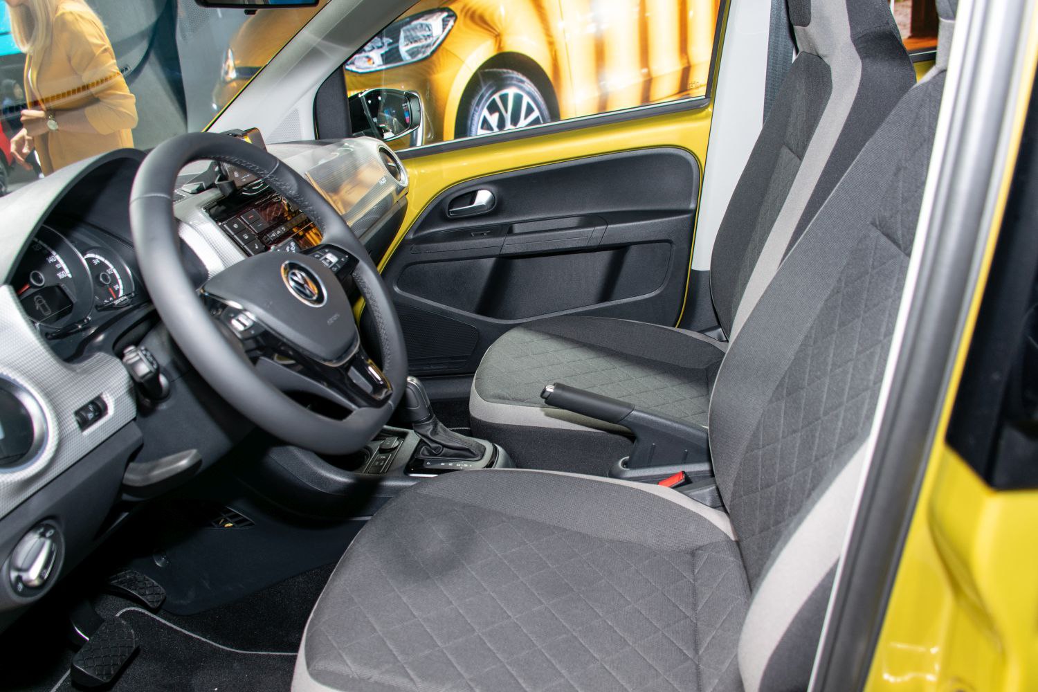 Steering wheel, dashboard, and front seats in a compact electric car interior