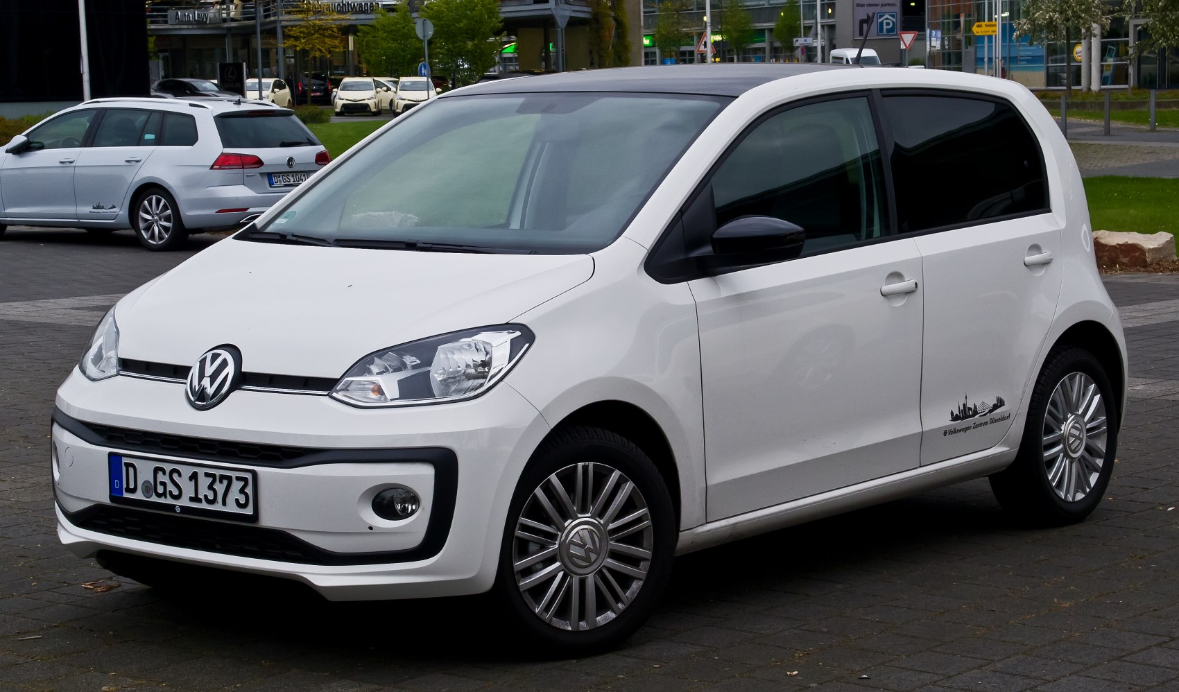 White compact hatchback showing front and side angles