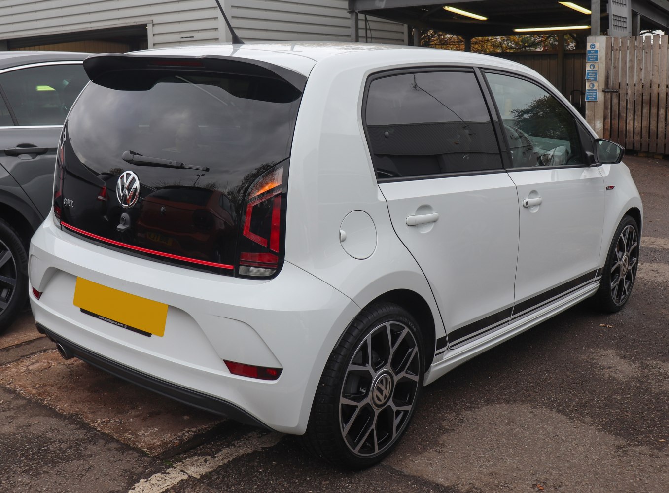 Rear and side profile showing taillights, black trim, and alloy wheels.