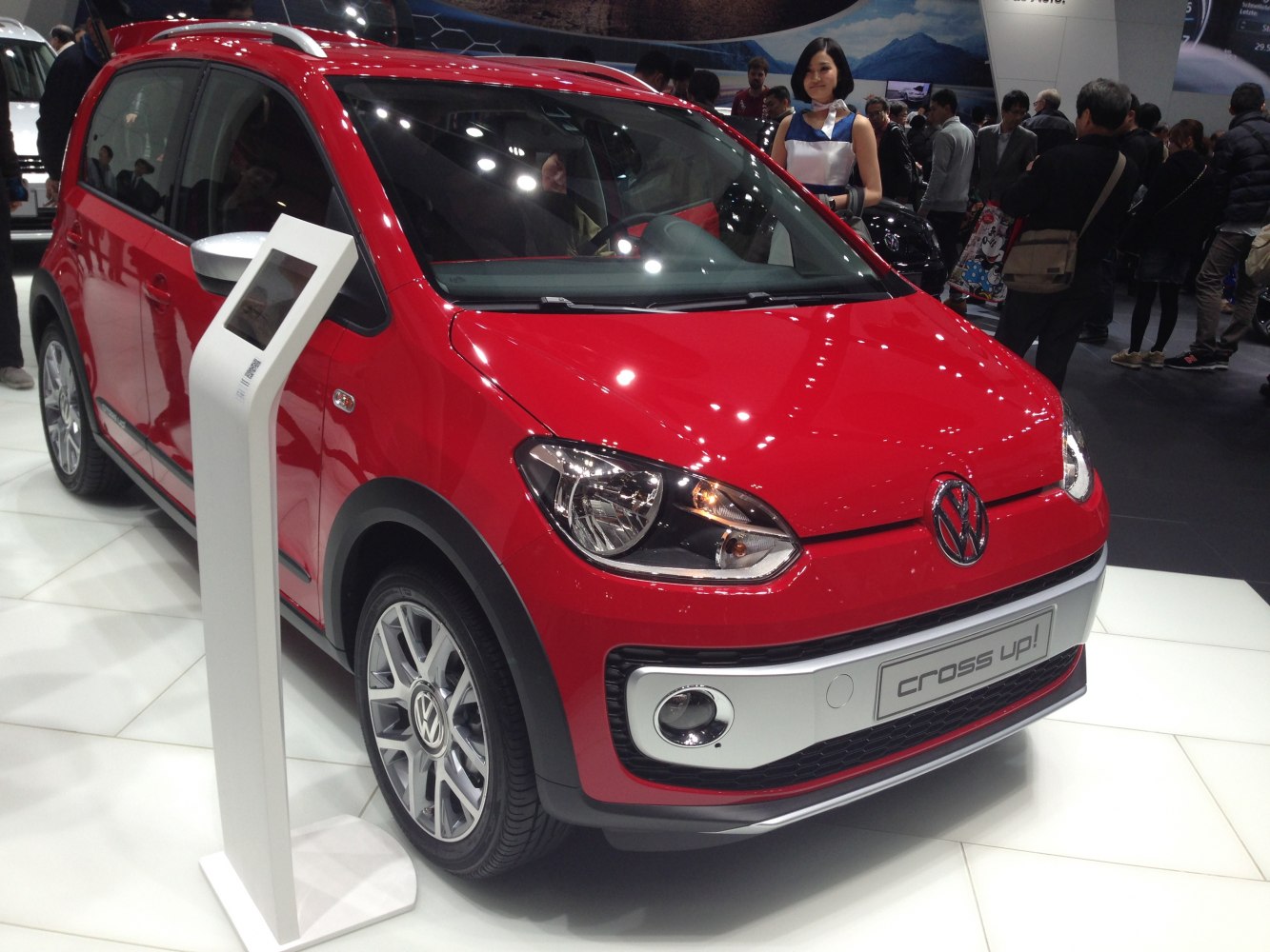 Red compact hatchback with silver accents, alloy wheels, and roof rails.