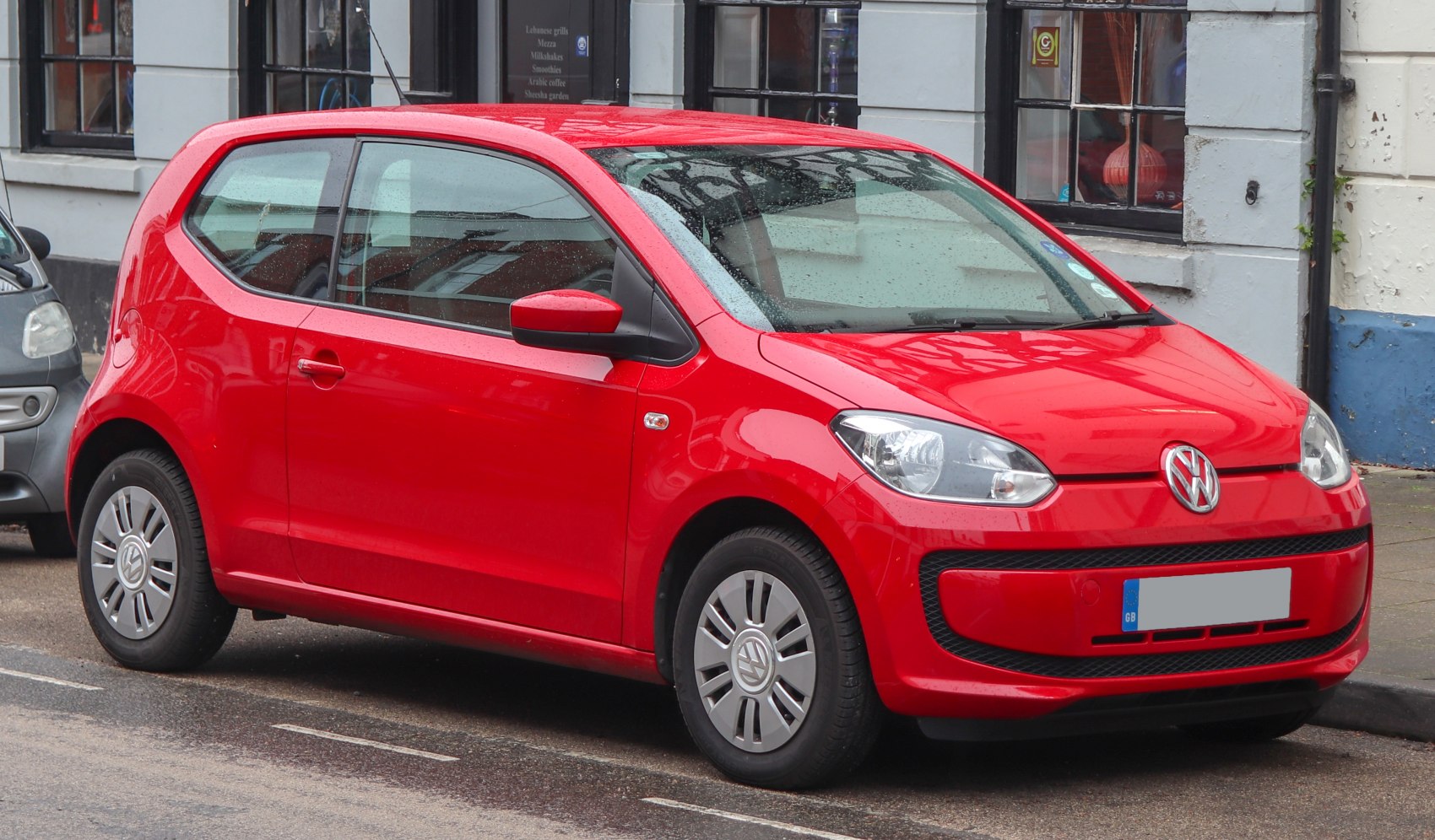 Red compact hatchback with front and side profile