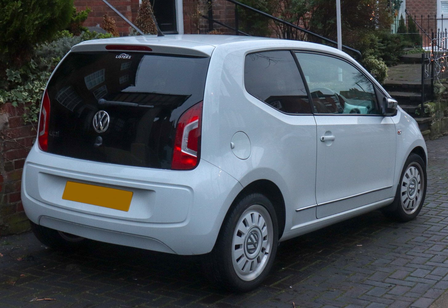 Rear side view with distinctive taillights and compact hatchback design