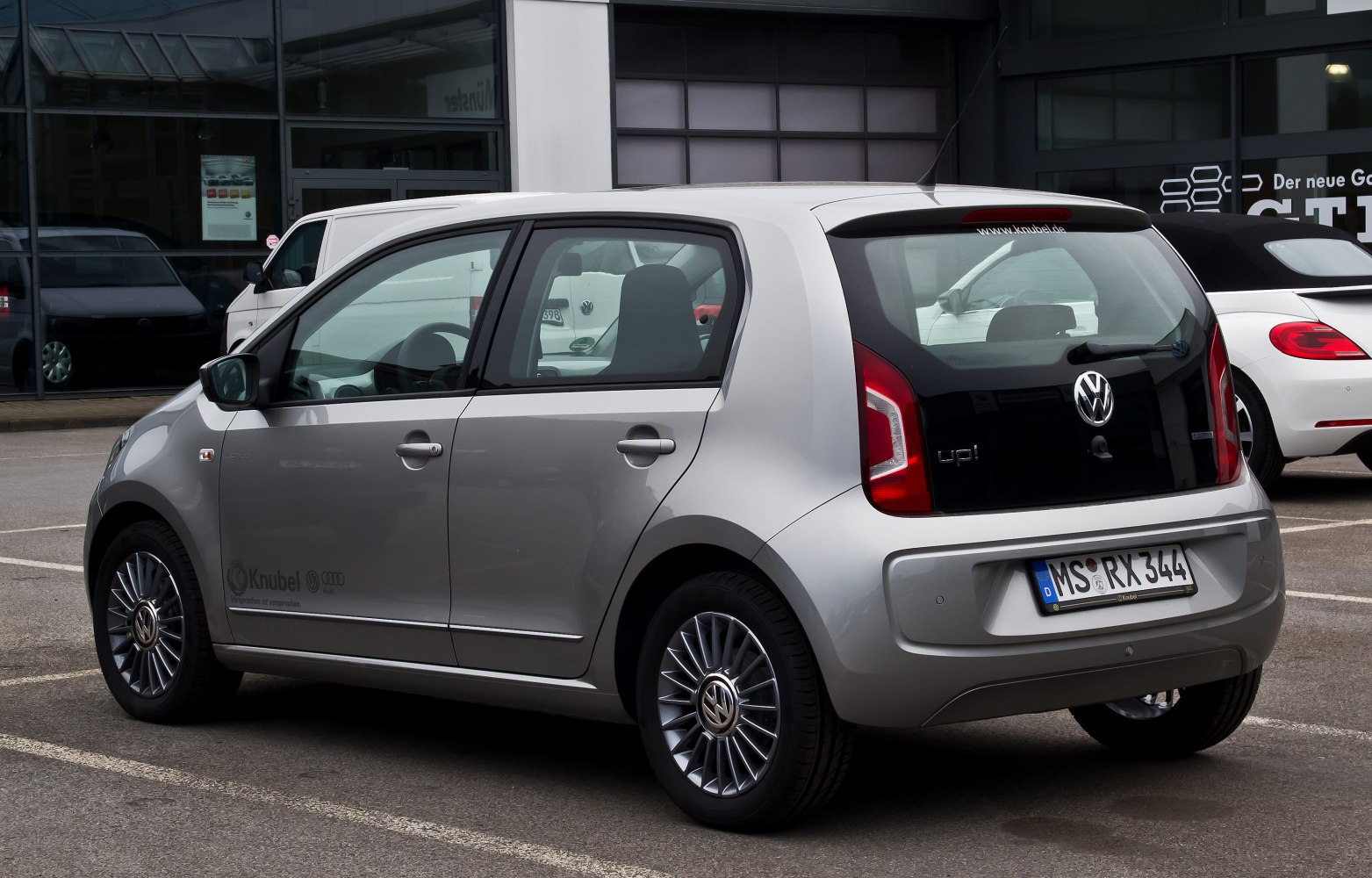 Compact silver hatchback with distinct rear light design and alloy wheels