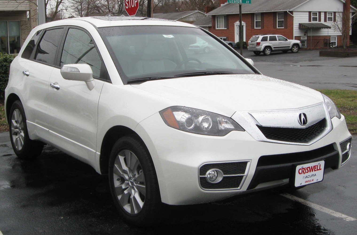 Front-side view of white mid-size SUV with distinct headlights and alloy wheels