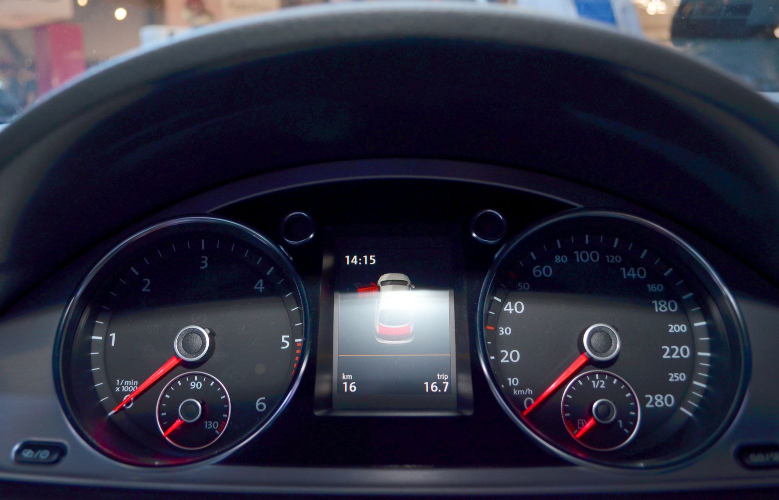 Instrument cluster with tachometer, speedometer, and central digital display