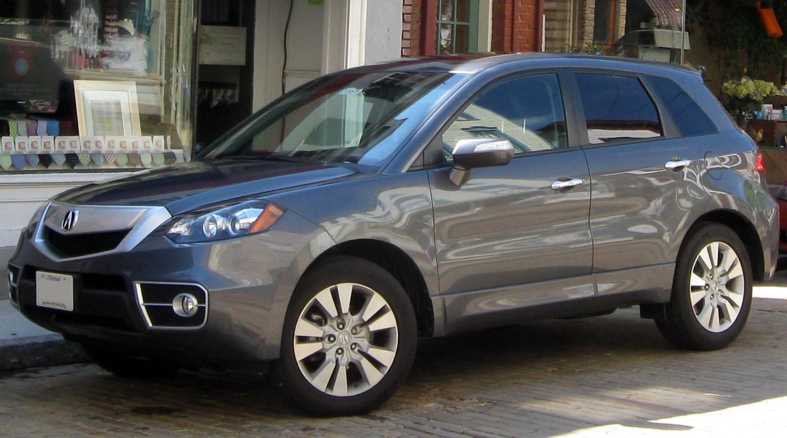 Front-side profile featuring headlights and multi-spoke alloy wheels