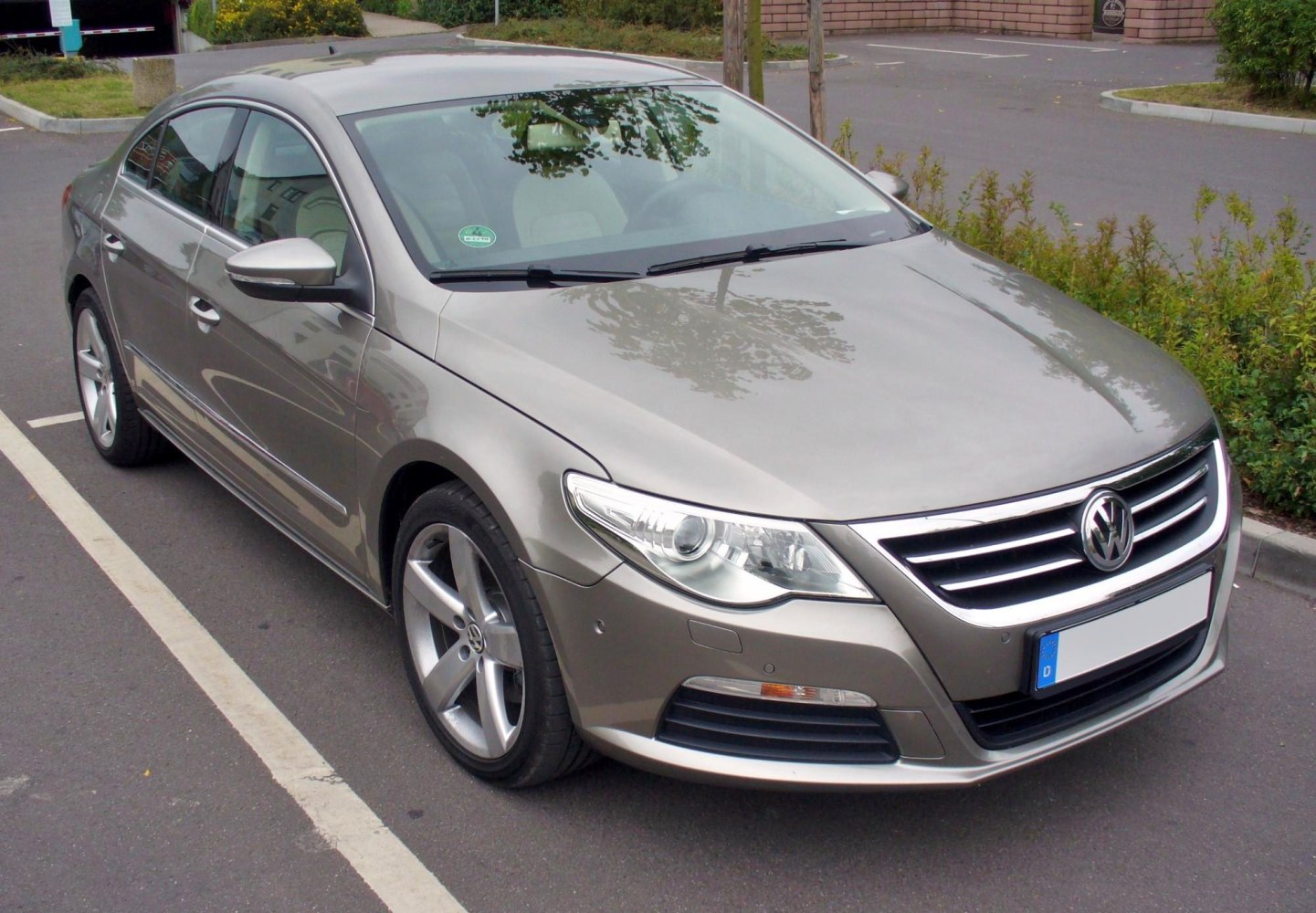 Front grille and alloy wheels of modern sedan with sleek headlights
