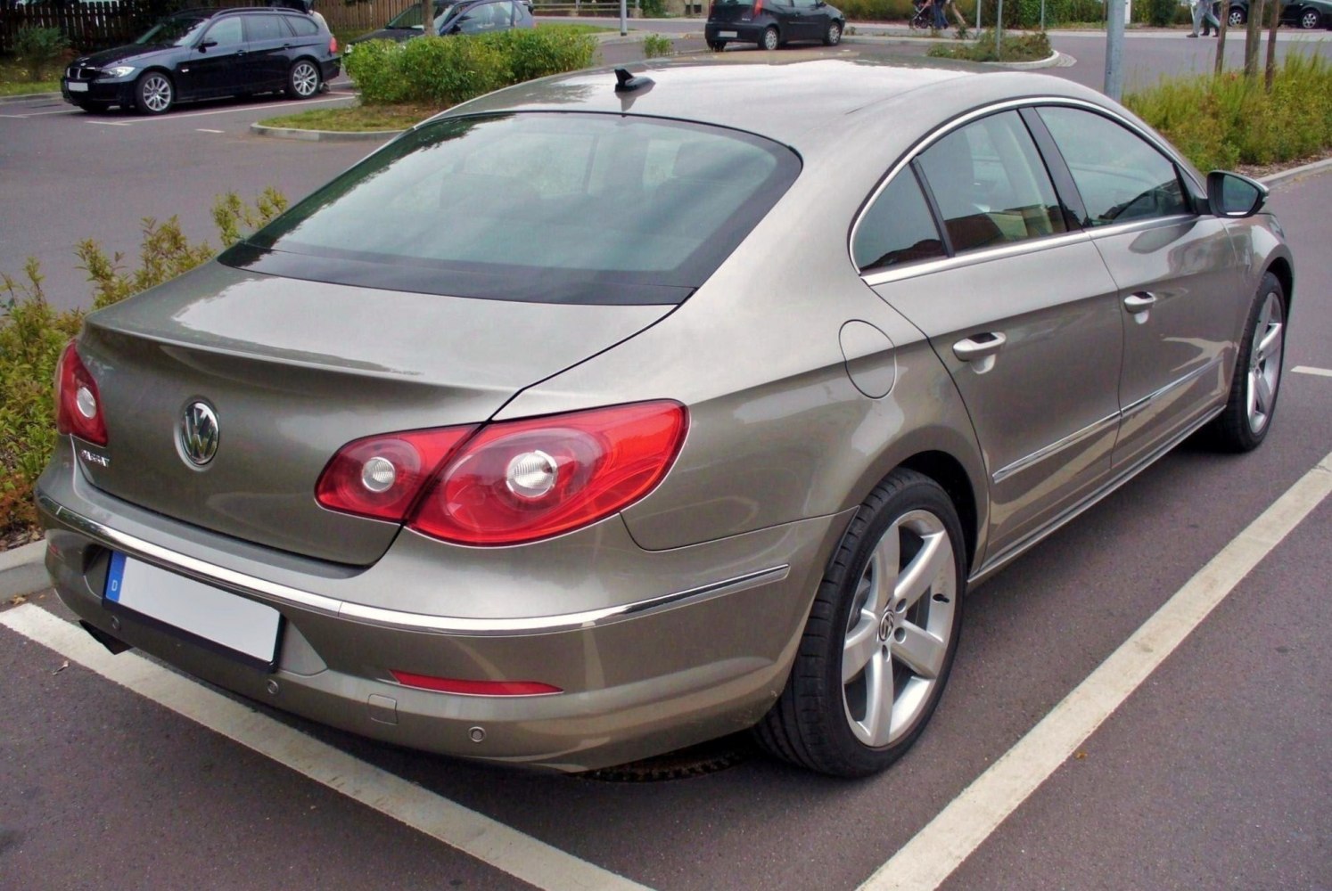 Rear side view with iconic tail lights and sleek sedan design
