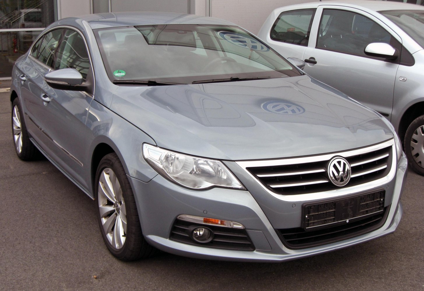 Front view of a modern sedan with sleek headlights and alloy wheels.