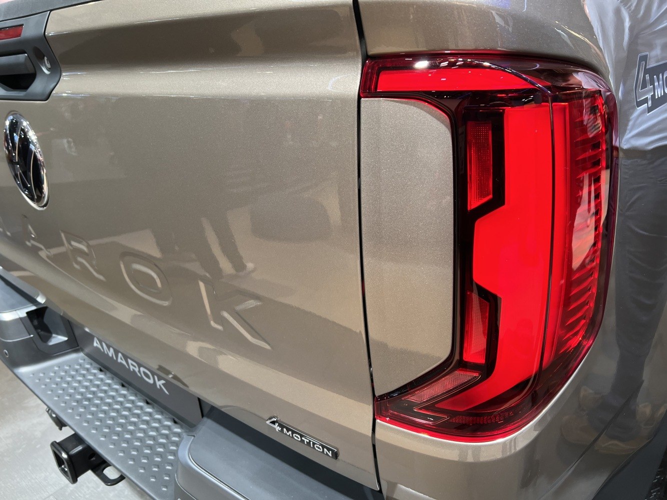 Close-up of rear tail light and 4MOTION badge on vehicle.