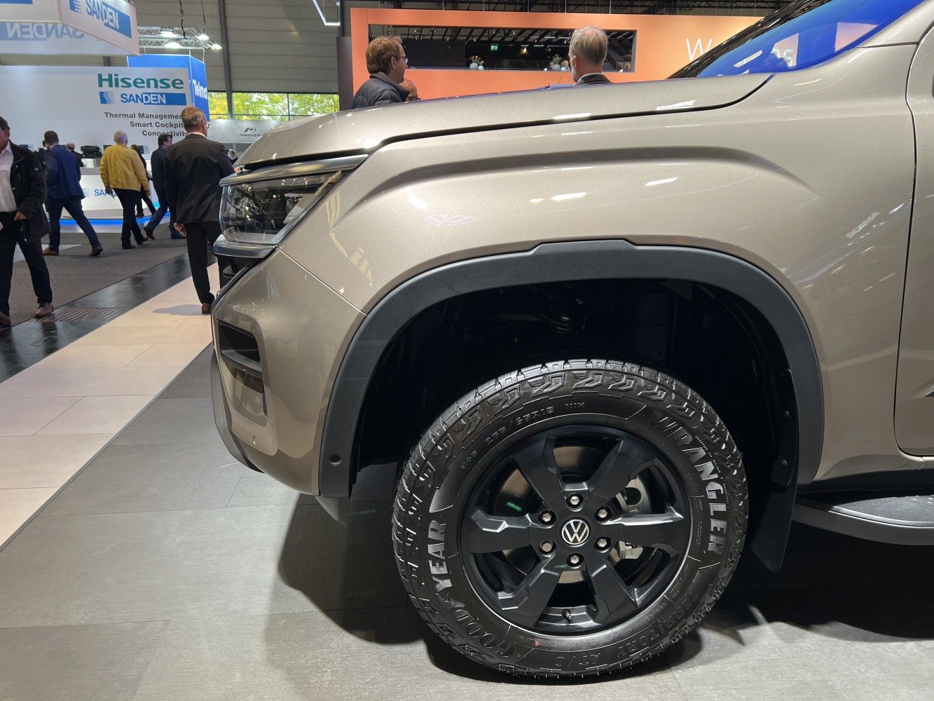 Close-up of front fender and black alloy wheel with off-road tire