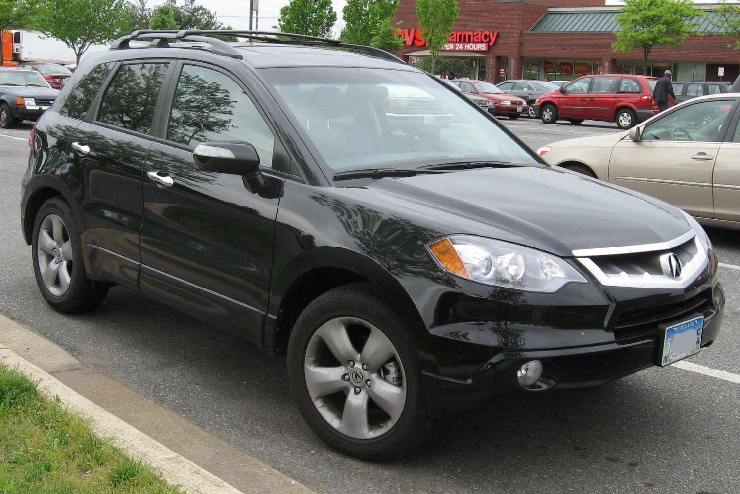 Front side view of a black compact SUV with alloy wheels and roof rails