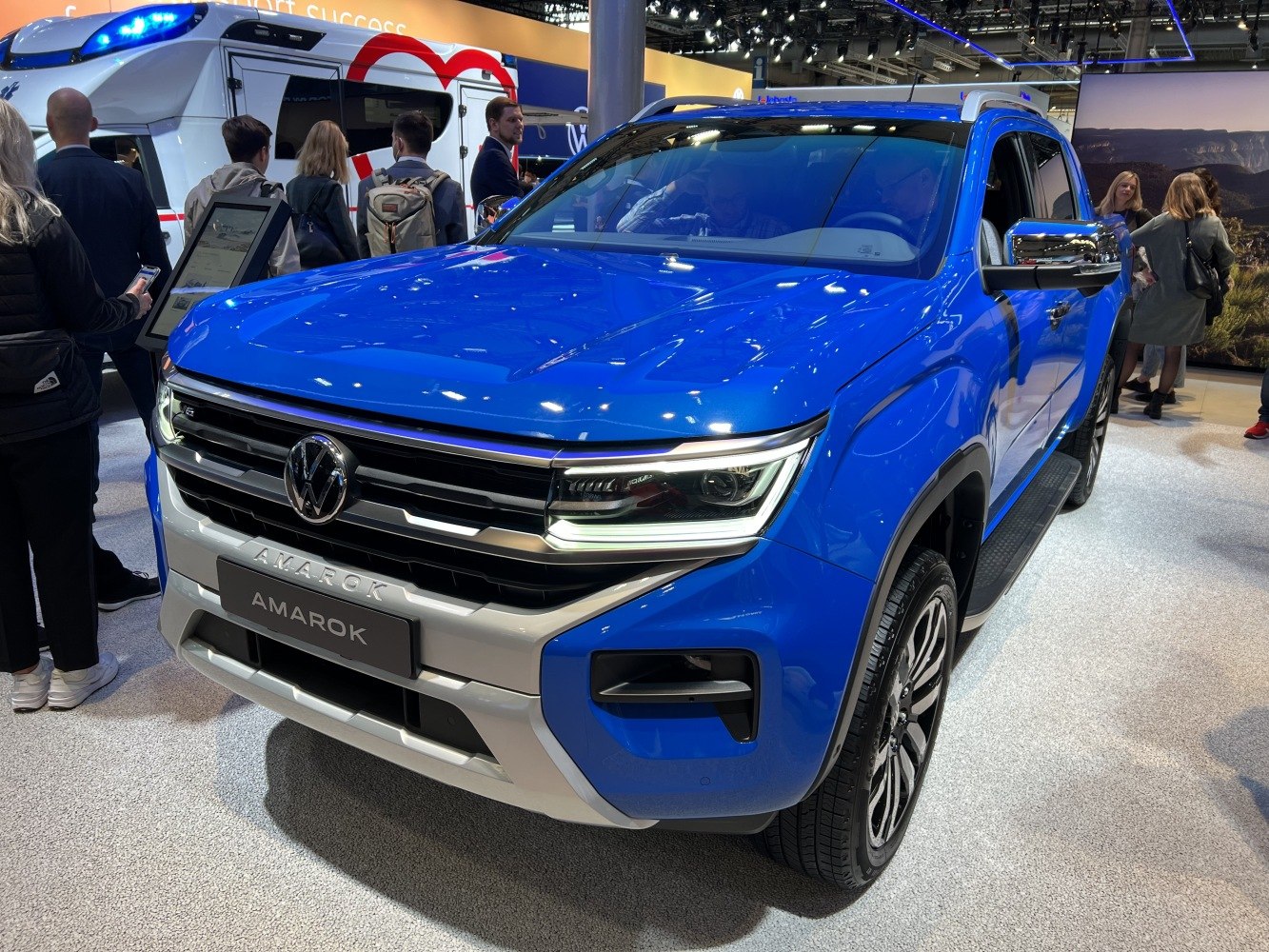 Front view of a blue pickup truck with LED headlights and rugged styling