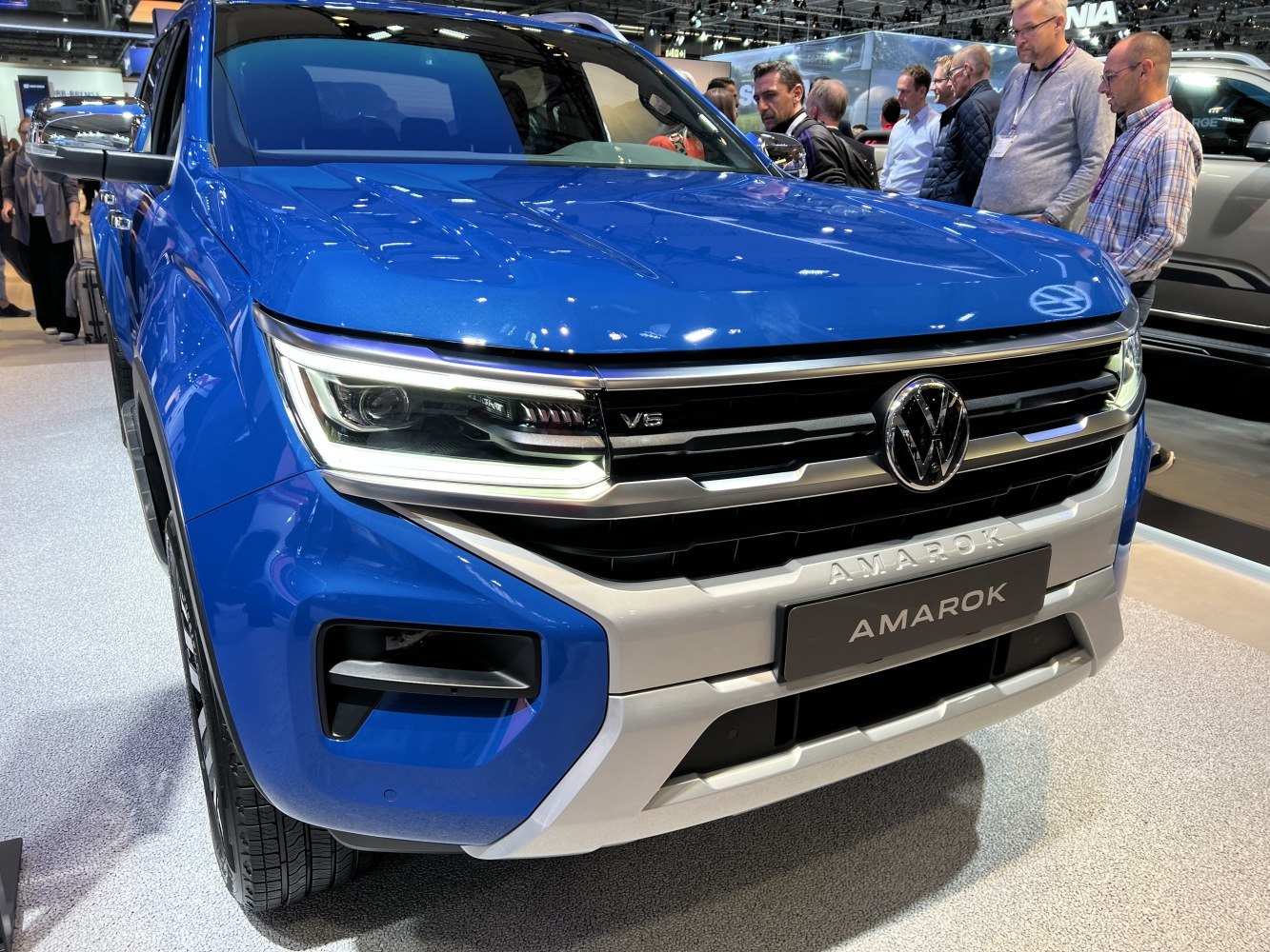 Front grille, LED headlights, and V6 badge of a blue pickup truck