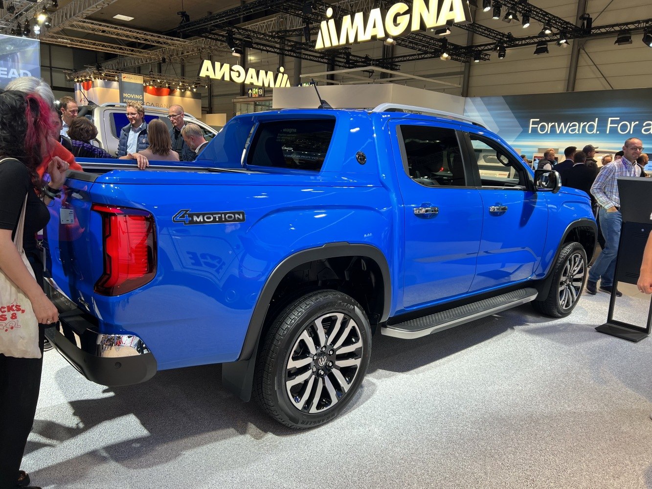 Blue pickup with 4MOTION badge and multi-spoke alloy wheels
