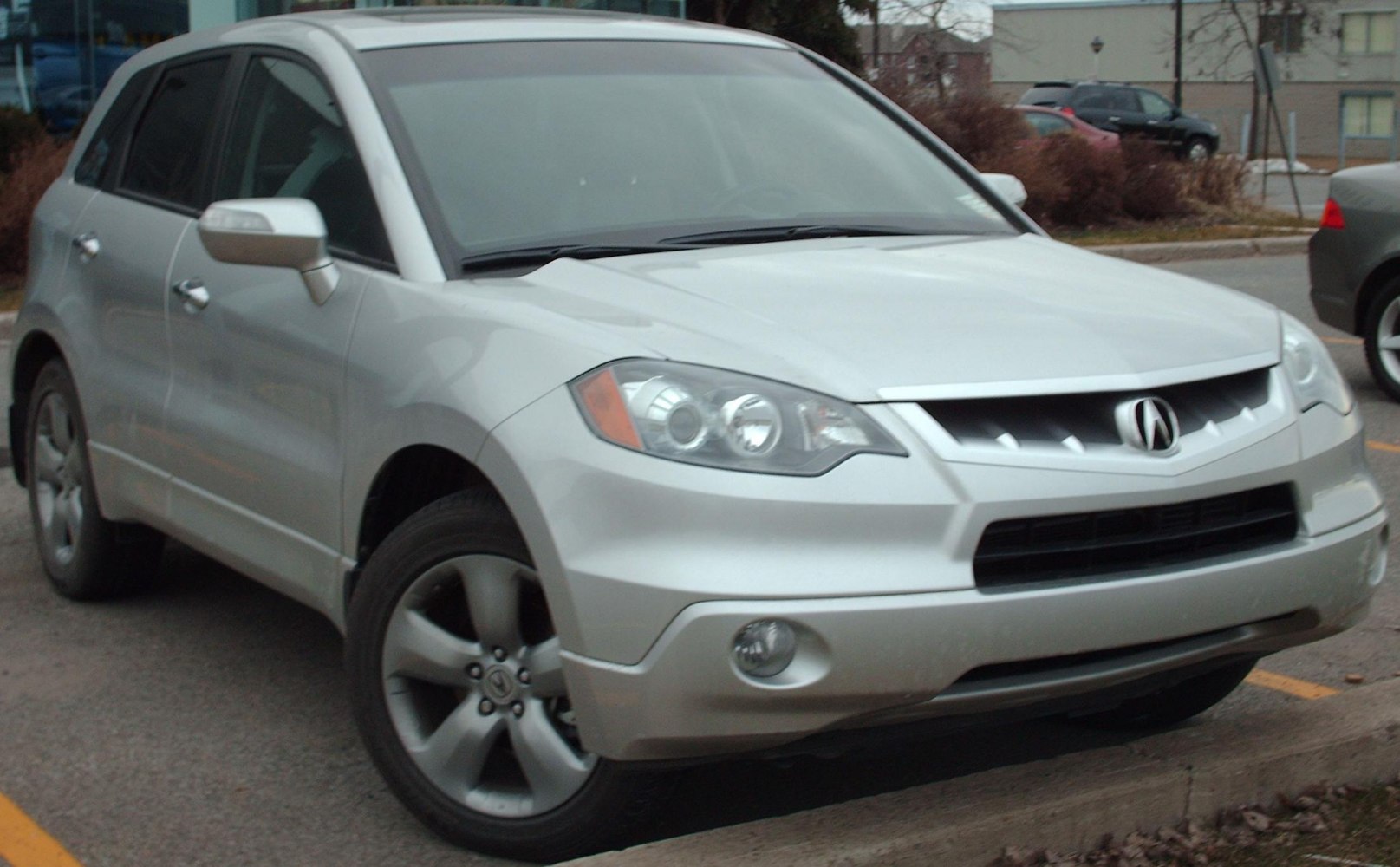 Front three-quarter view of silver SUV with distinct headlights and grille.