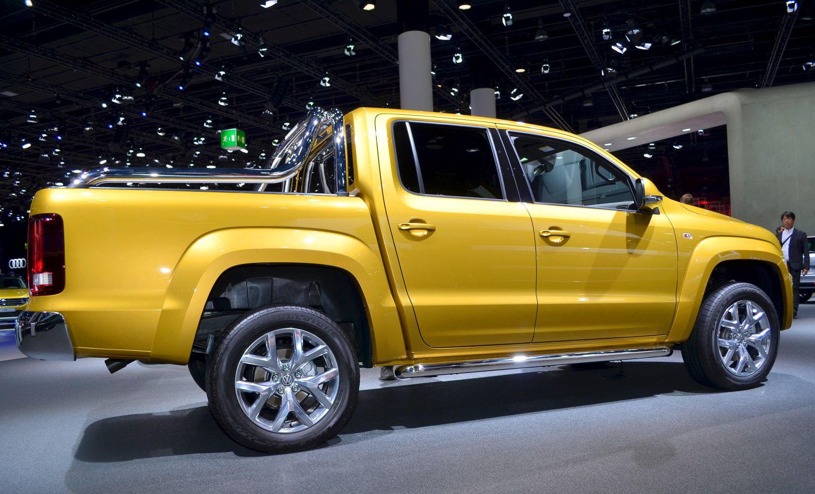 Yellow pickup truck with chrome roll bar and alloy wheels side view