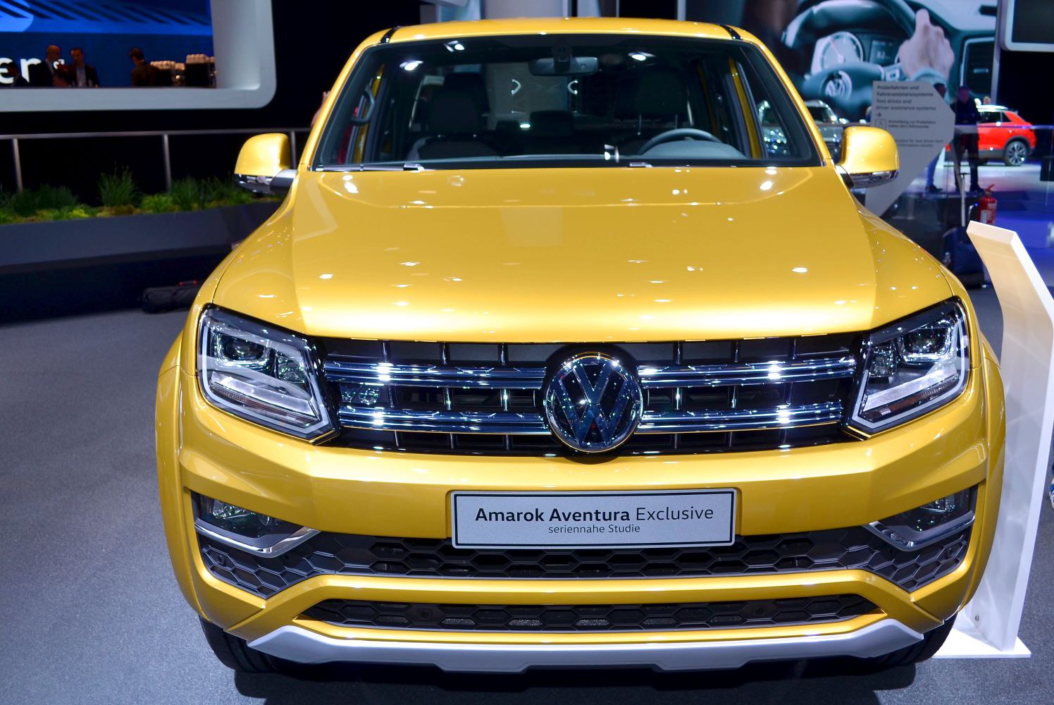 Front view showing headlights and grille of a yellow pickup truck