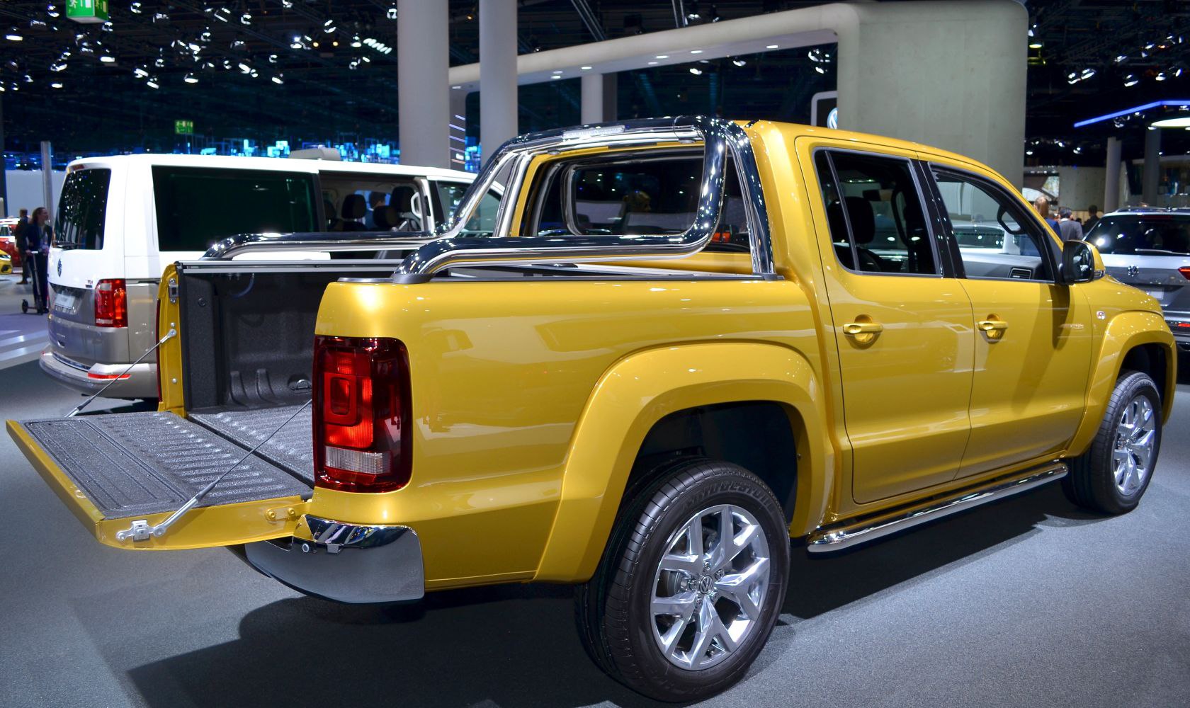 Yellow Double Cab pickup truck with chrome roll bar and open tailgate