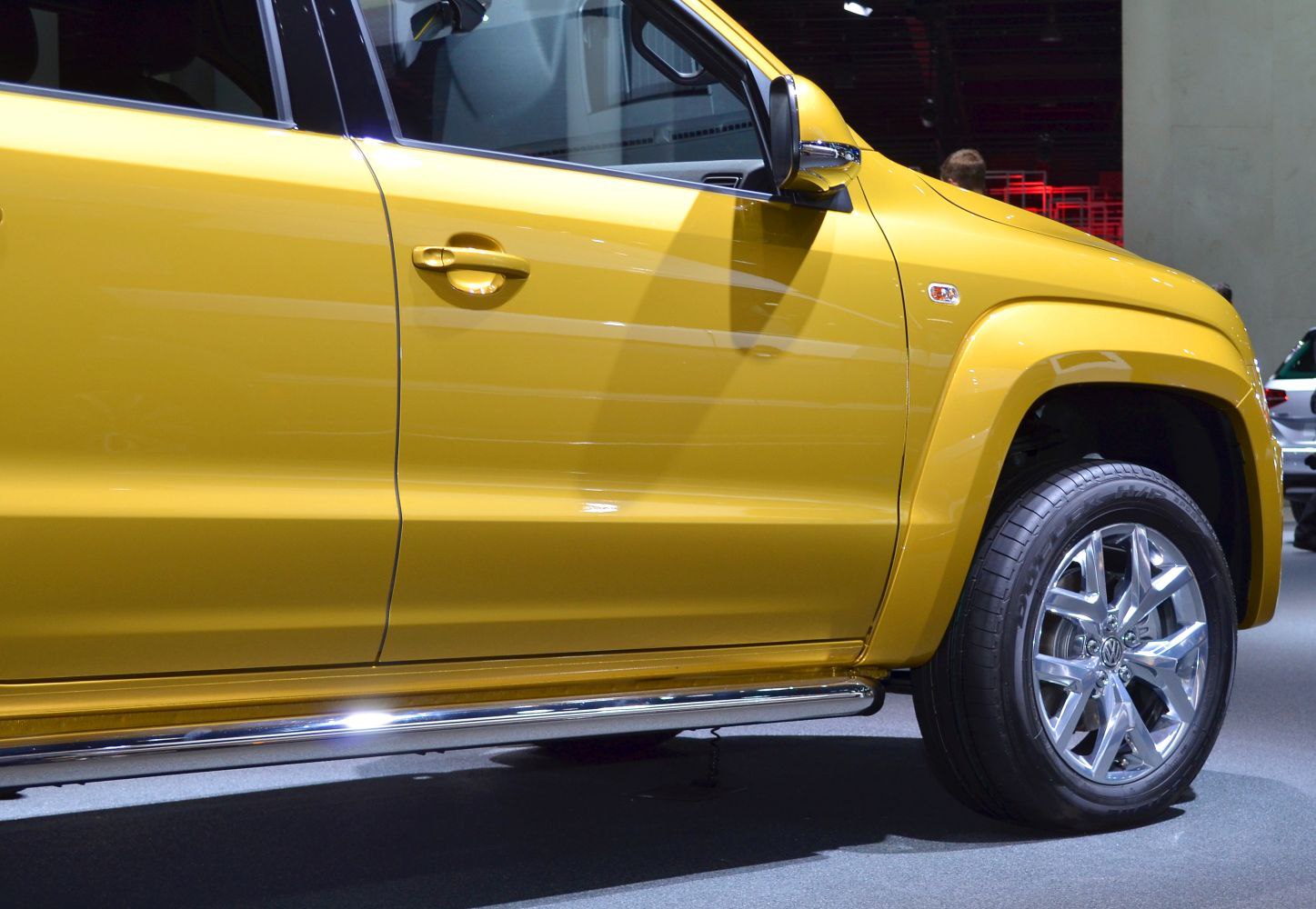 Yellow pick-up truck side with alloy wheels and chrome side step
