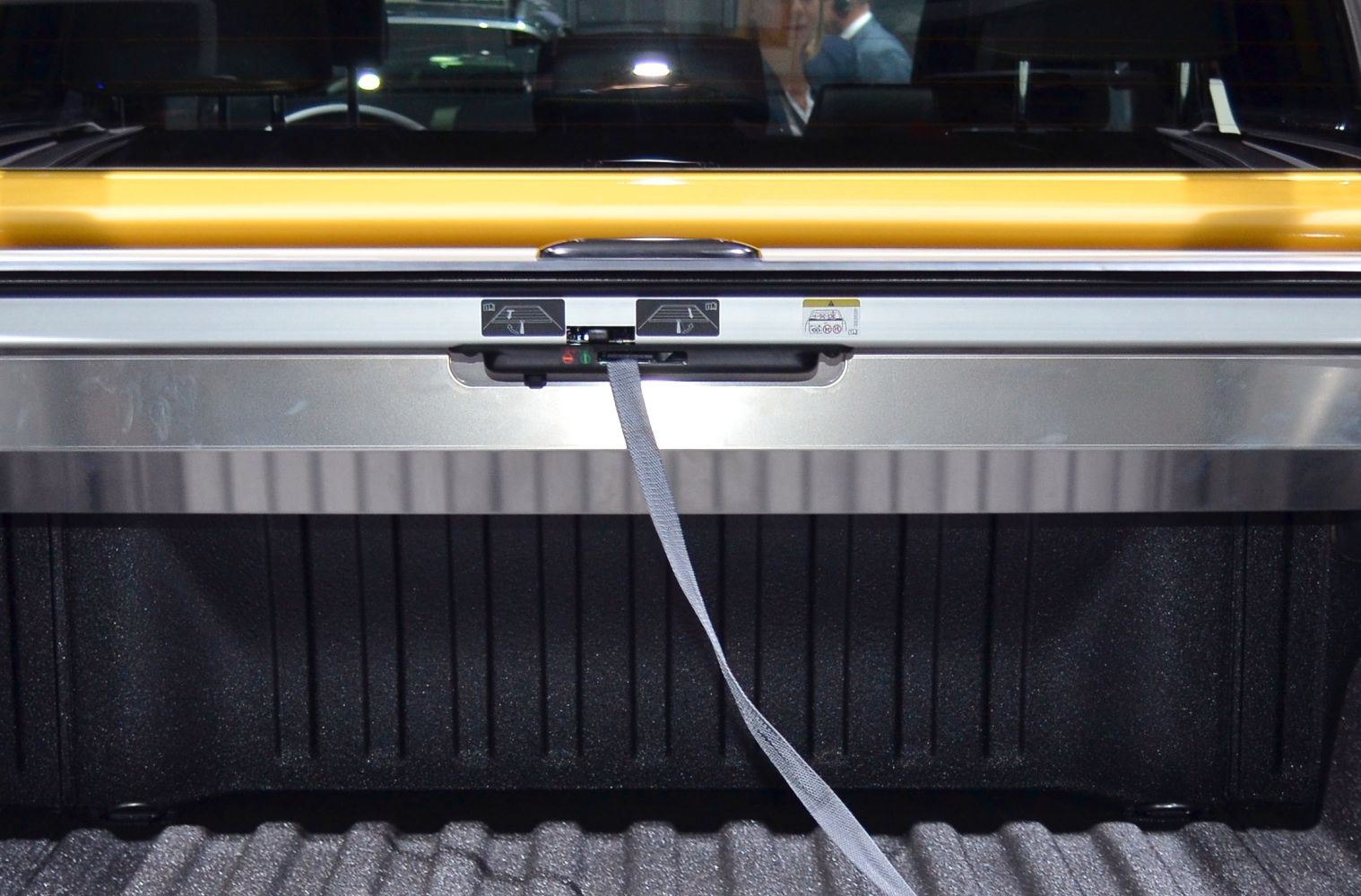 Close-up of pickup tailgate with integrated cargo securing strap