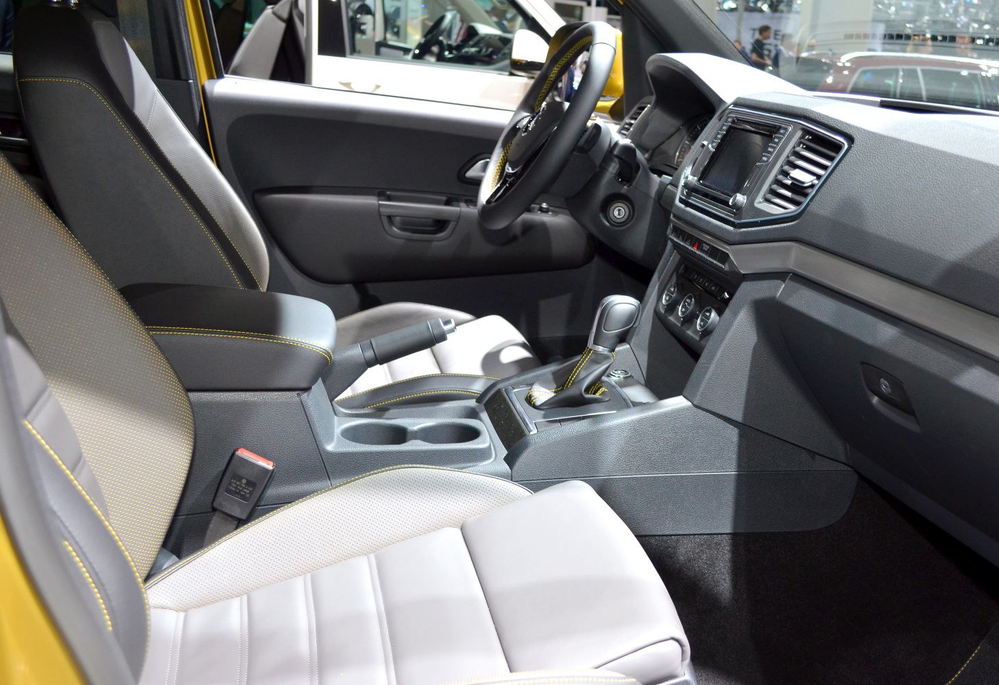 Leather seats and modern dashboard with gear shift and cup holders