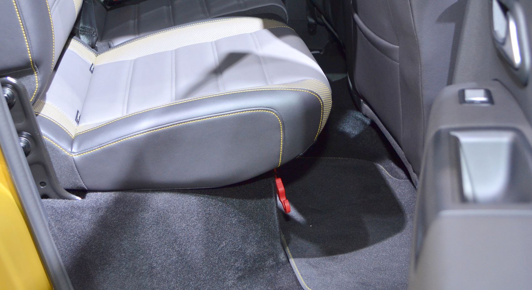Rear seat and floor area with leather-fabric upholstery and detailed stitching