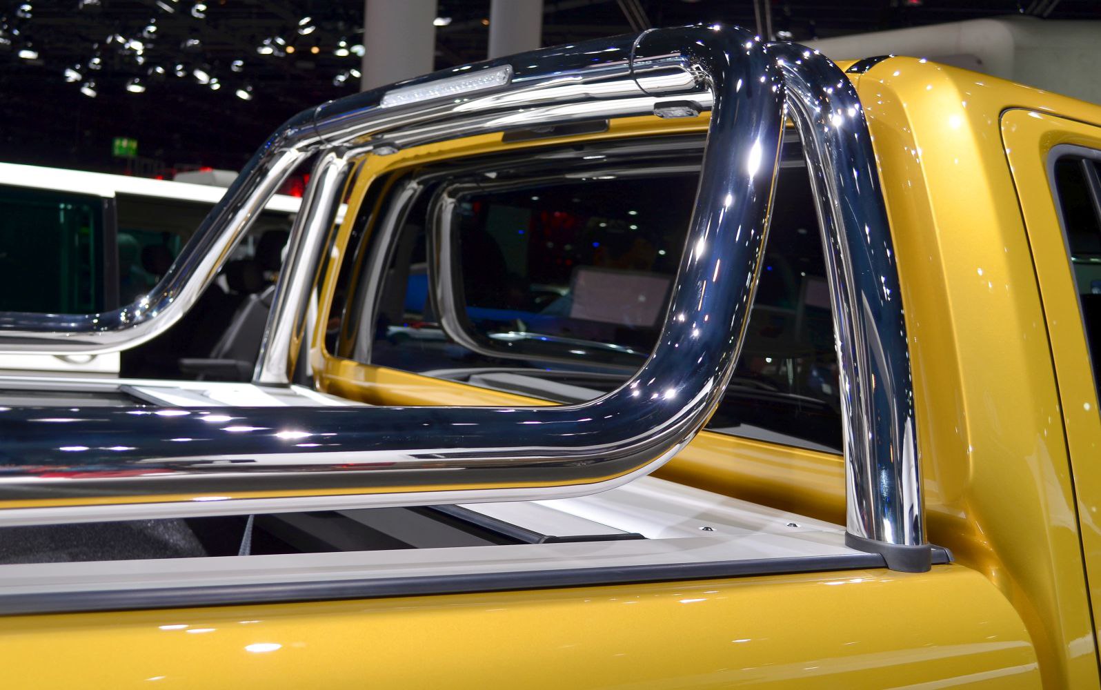Shiny chrome roll bar on yellow pickup bed