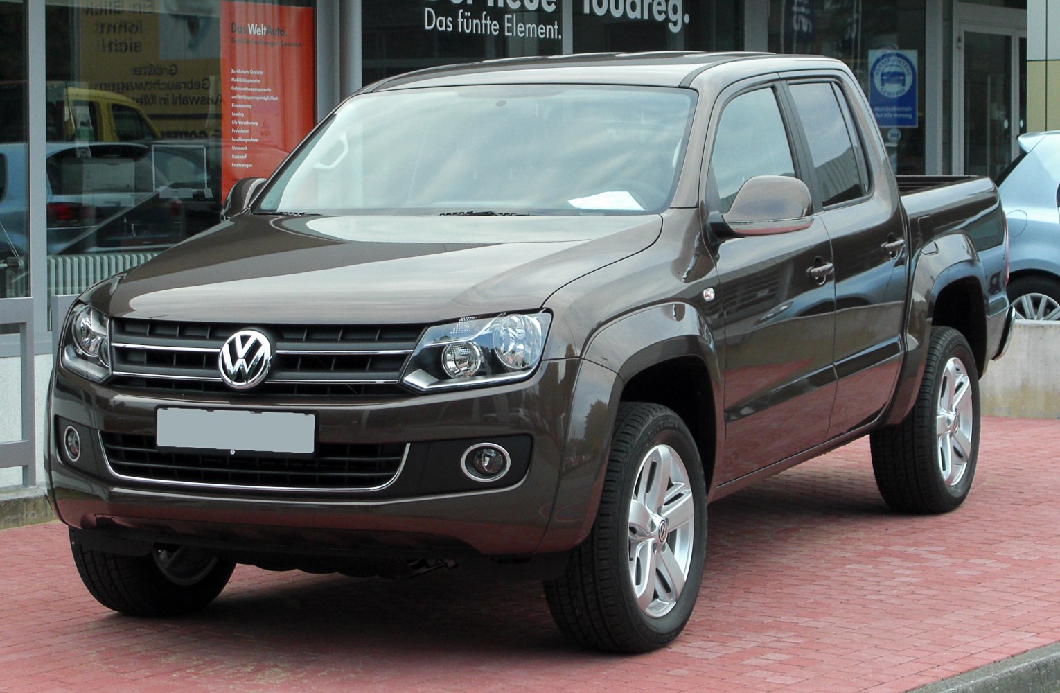 Pickup truck front view with distinctive grille and headlight design.