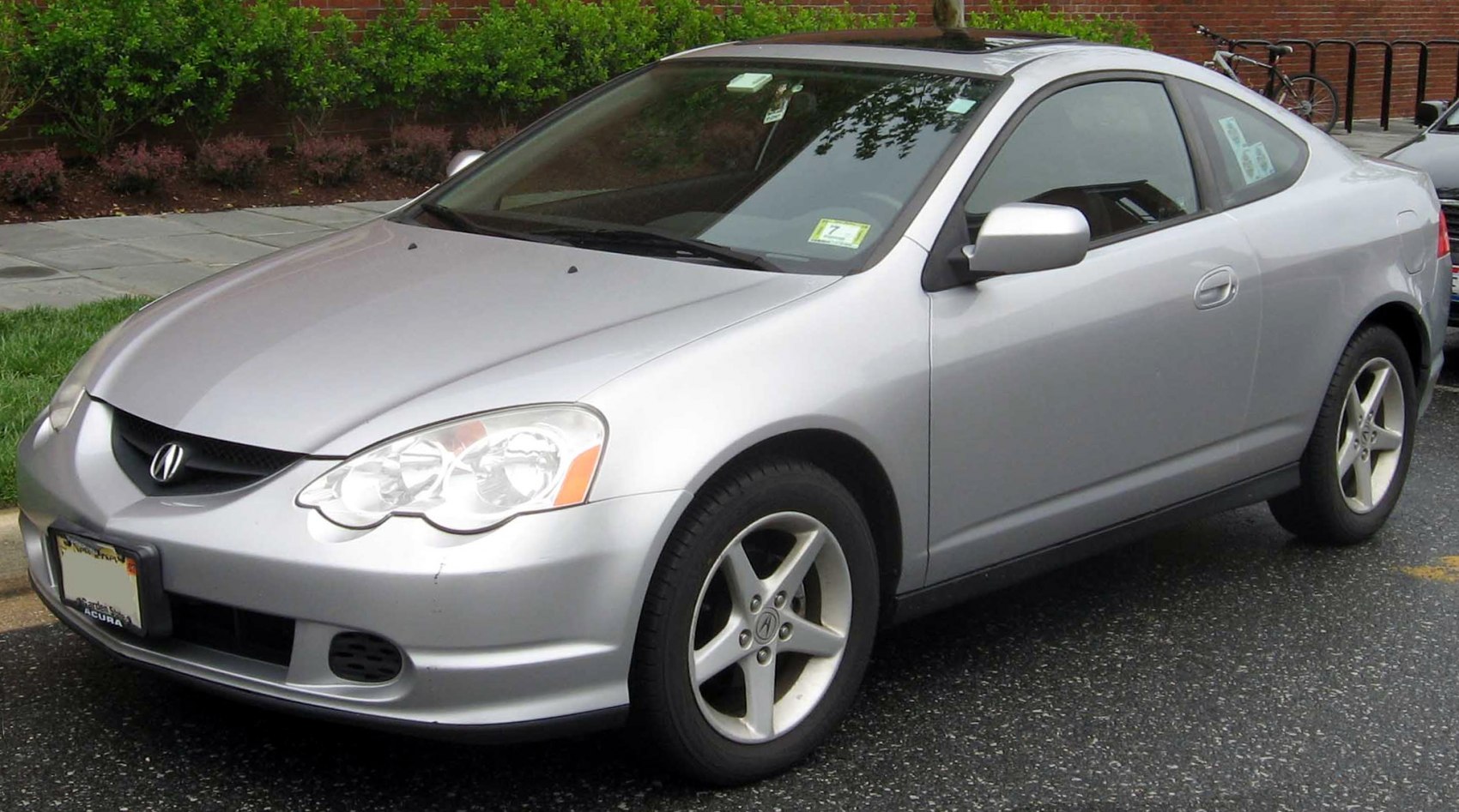 Silver coupe with sporty alloy wheels front 3-quarter angle