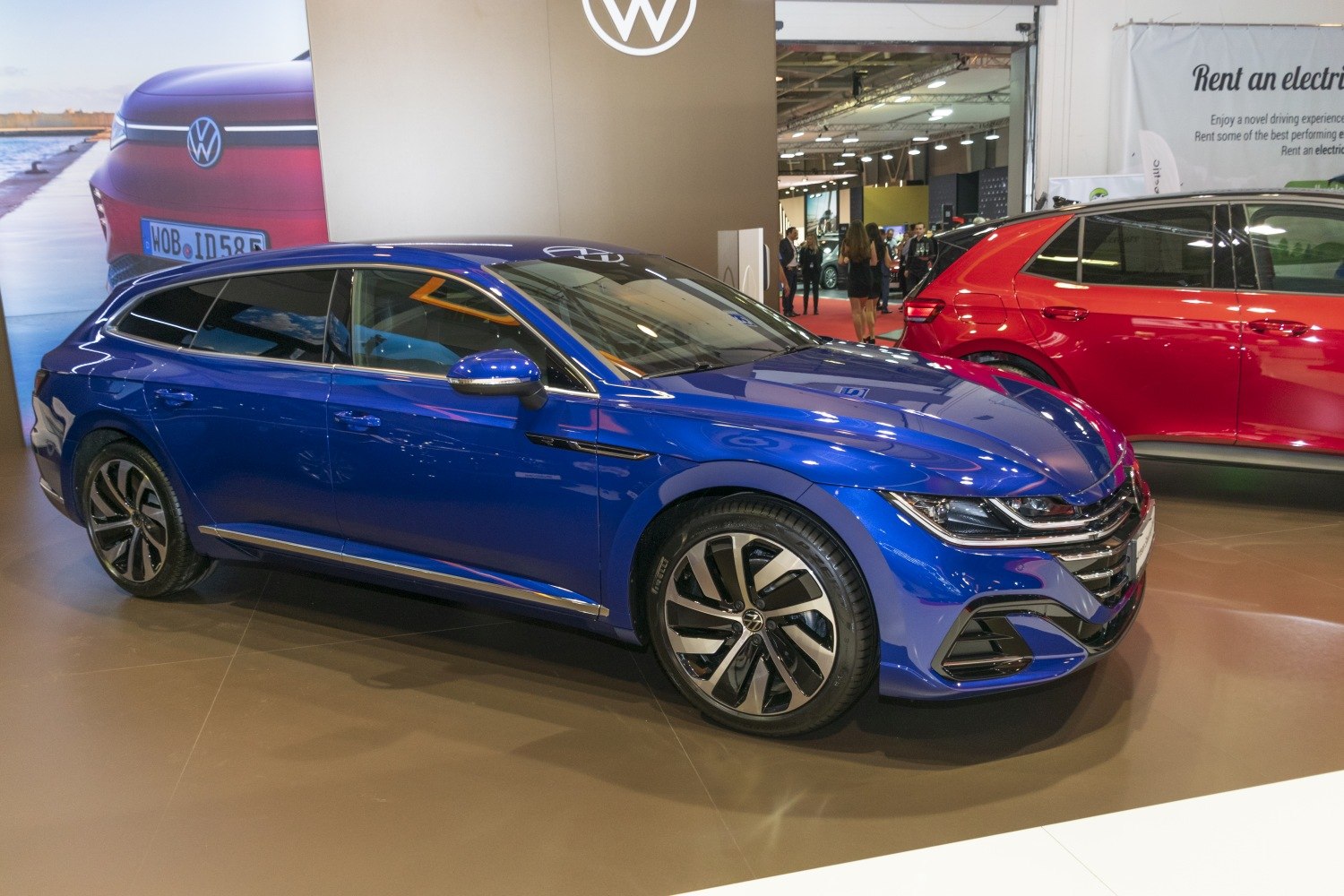 Sleek blue luxury shooting brake with alloy wheels and aerodynamic design