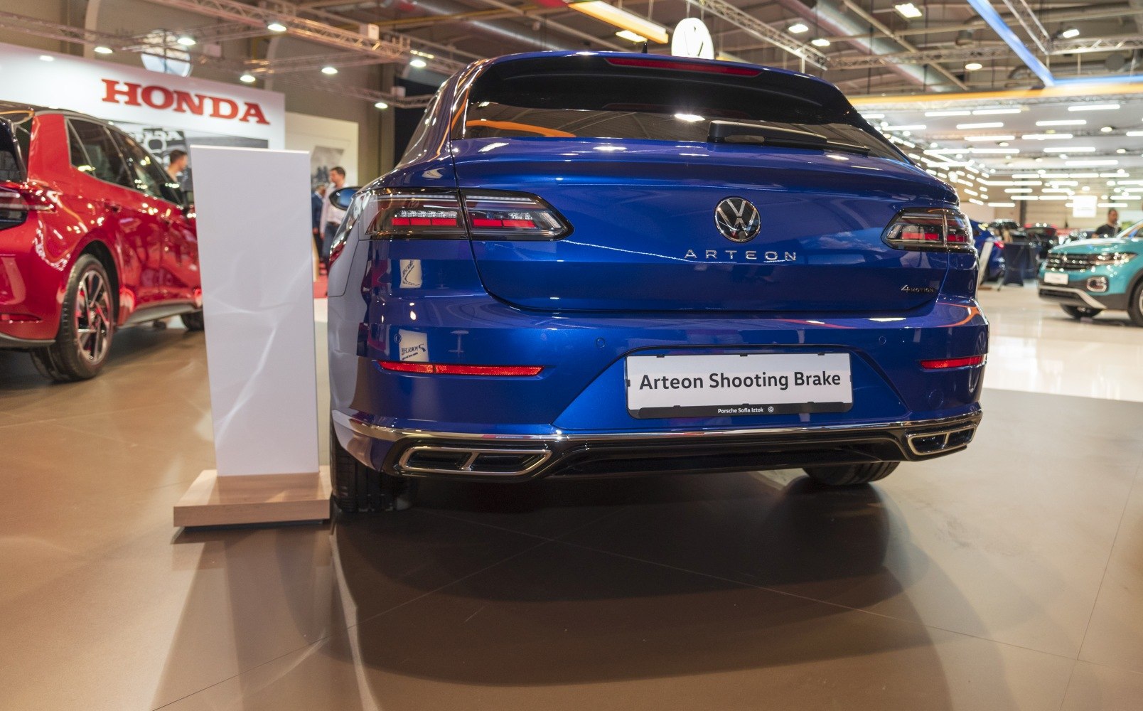 Rear view of a blue luxury shooting brake with modern taillights and dual exhausts
