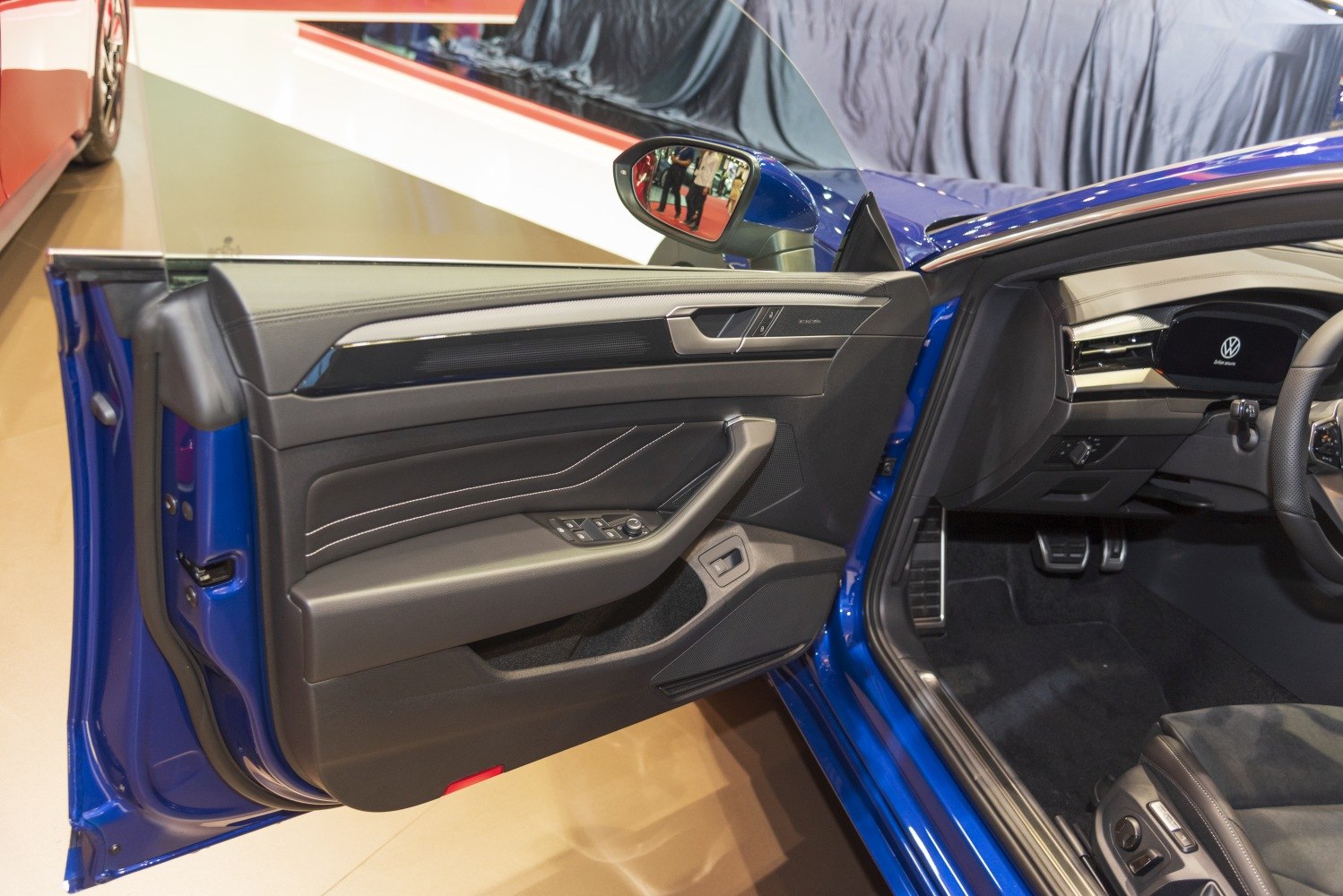 Interior door panel and driver dashboard with controls and pedals