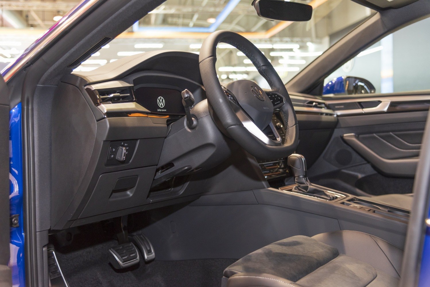 Modern digital dashboard and leather steering wheel interior
