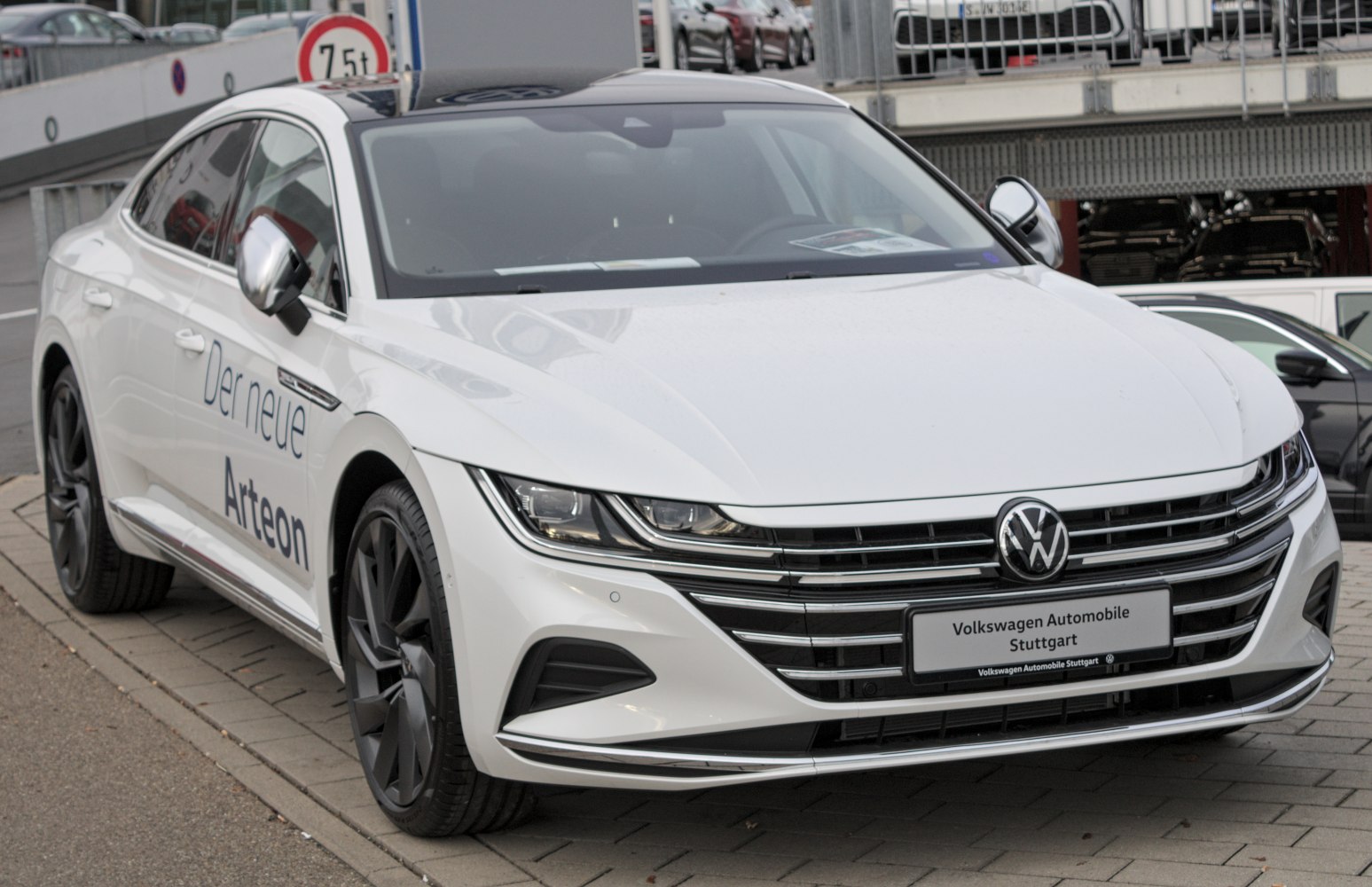 Sleek front grille and sharp LED headlights on a white sedan