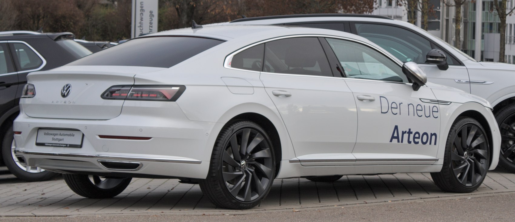 White Volkswagen Arteon facelift 2020 rear and side view with black alloy wheels