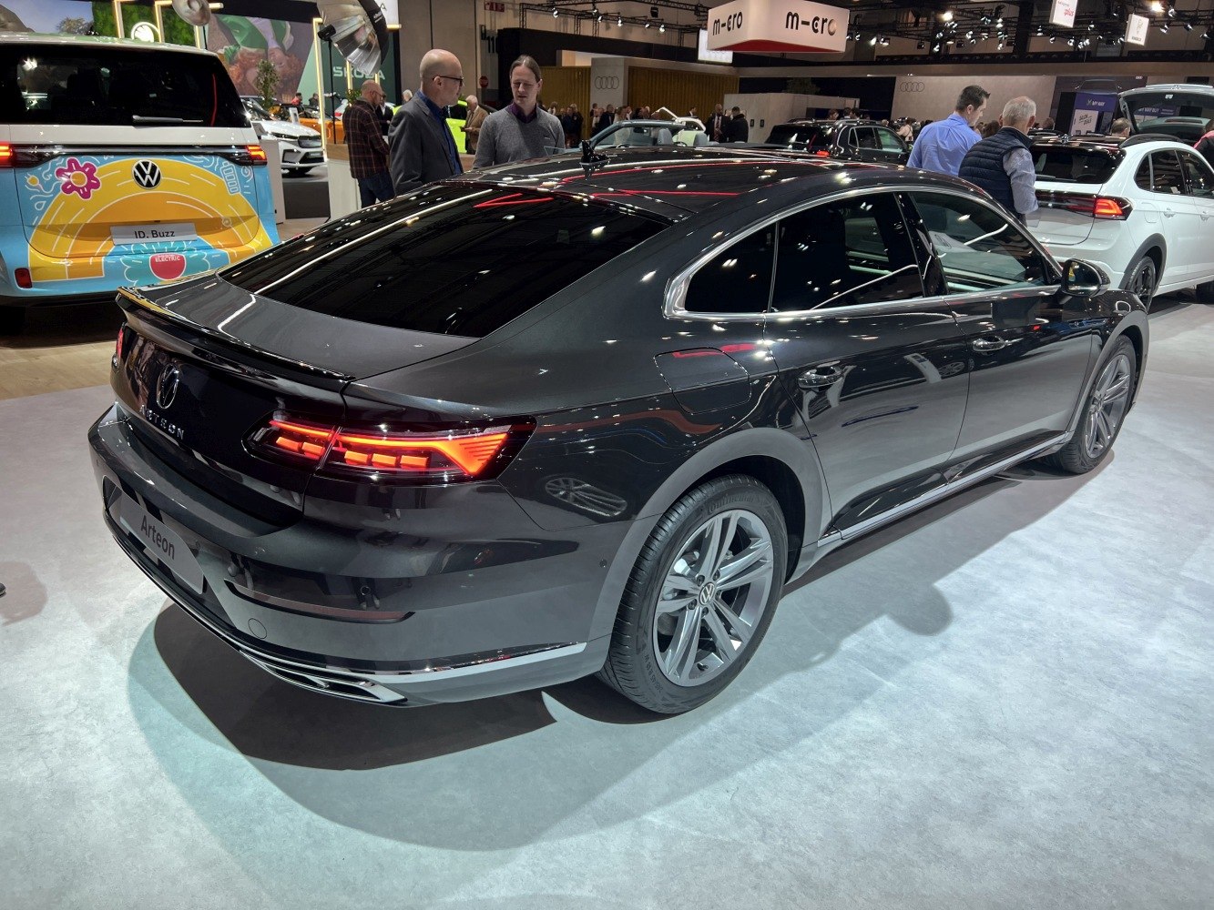 Rear and side view with illuminated tail lights and sleek aerodynamic shape