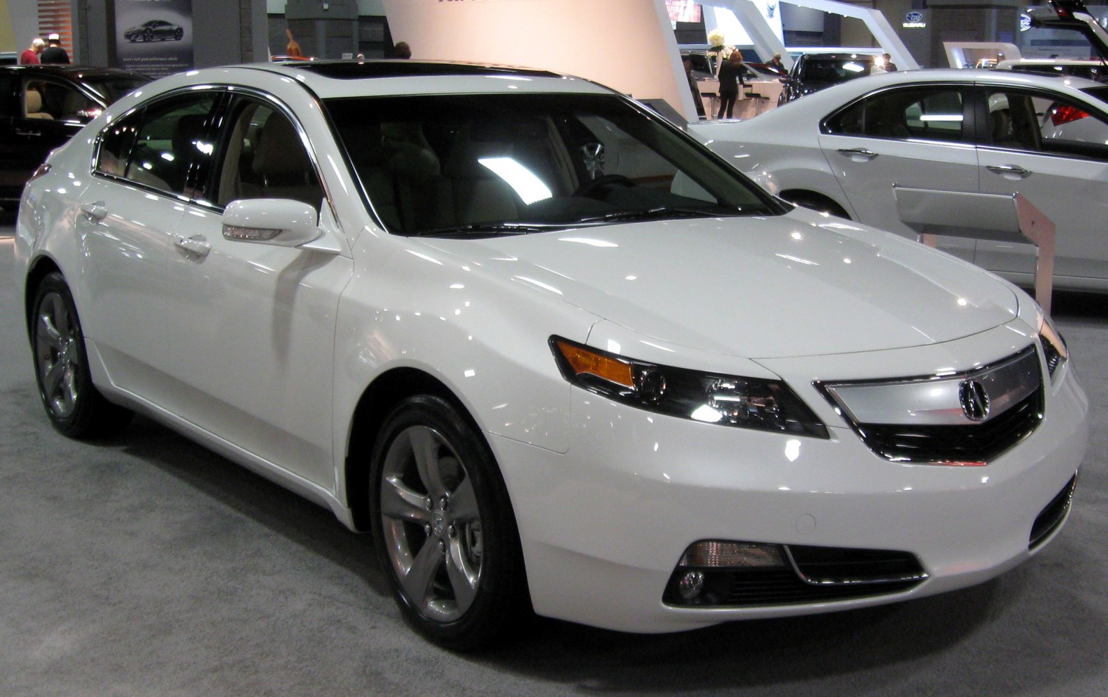 Luxury white sedan with bold front grille and LED headlights