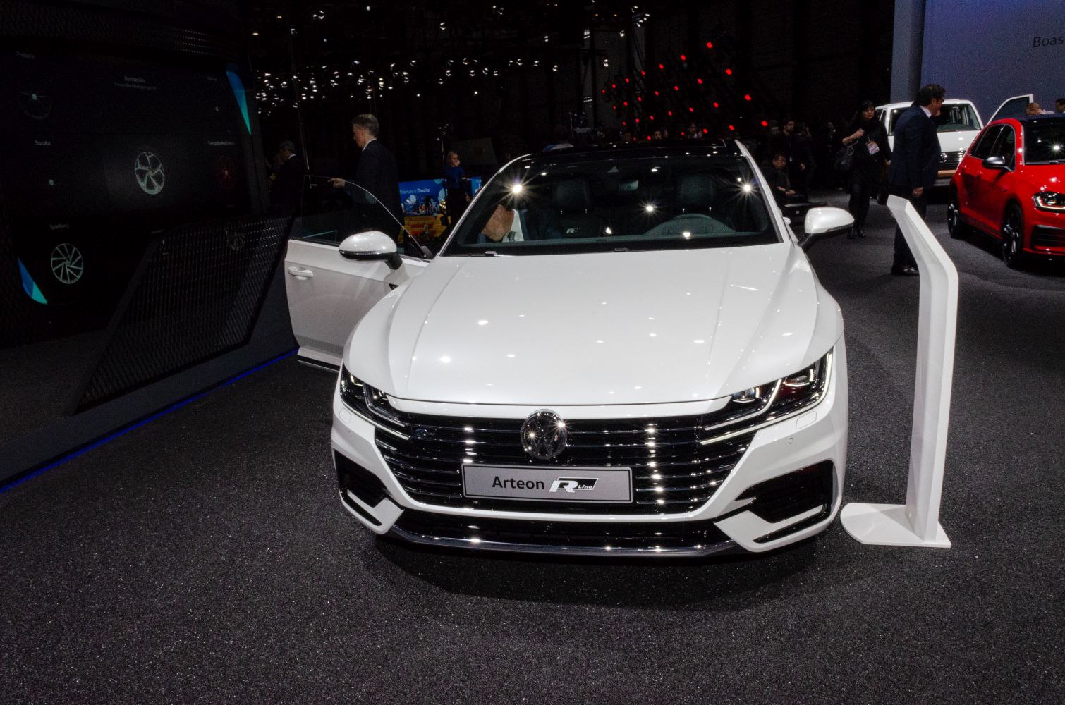 White luxury sedan front view with LED headlights and sleek grille