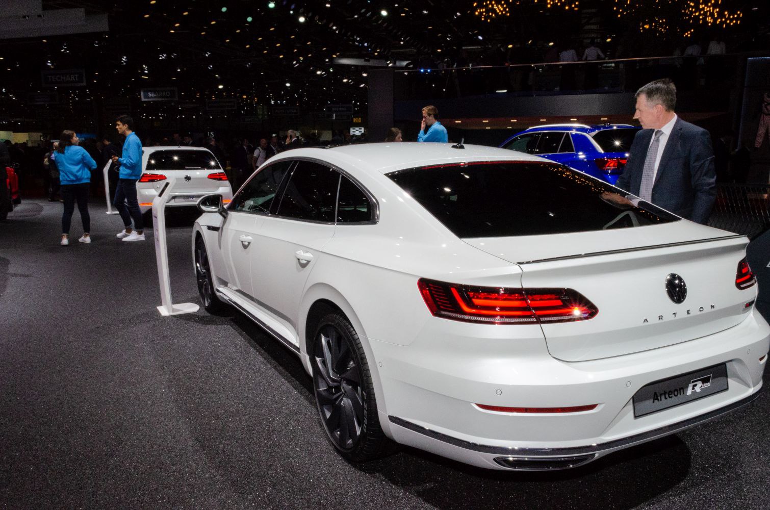 Rear view of white sedan with LED taillights and rear spoiler