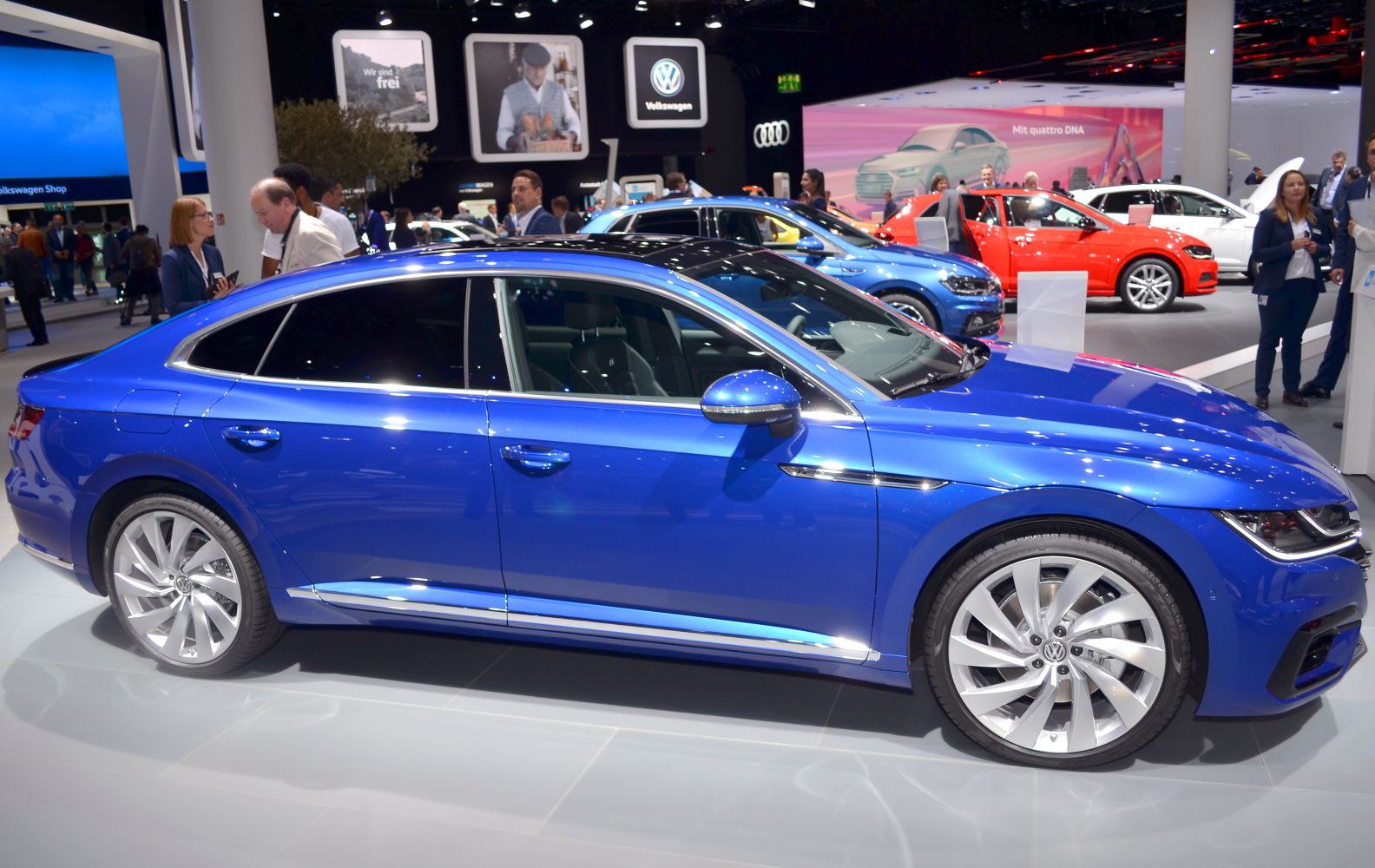 Side profile view with alloy wheels and blue exterior