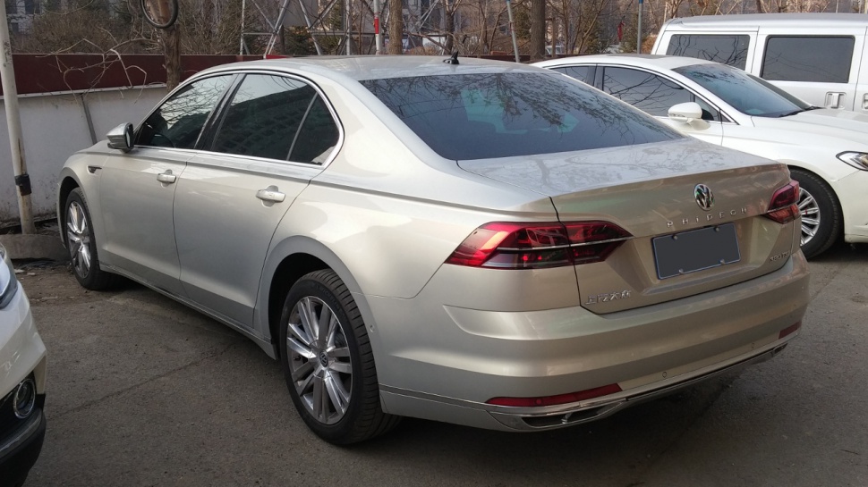 Rear and side view of a luxury sedan with sleek tail lights and smooth body lines.