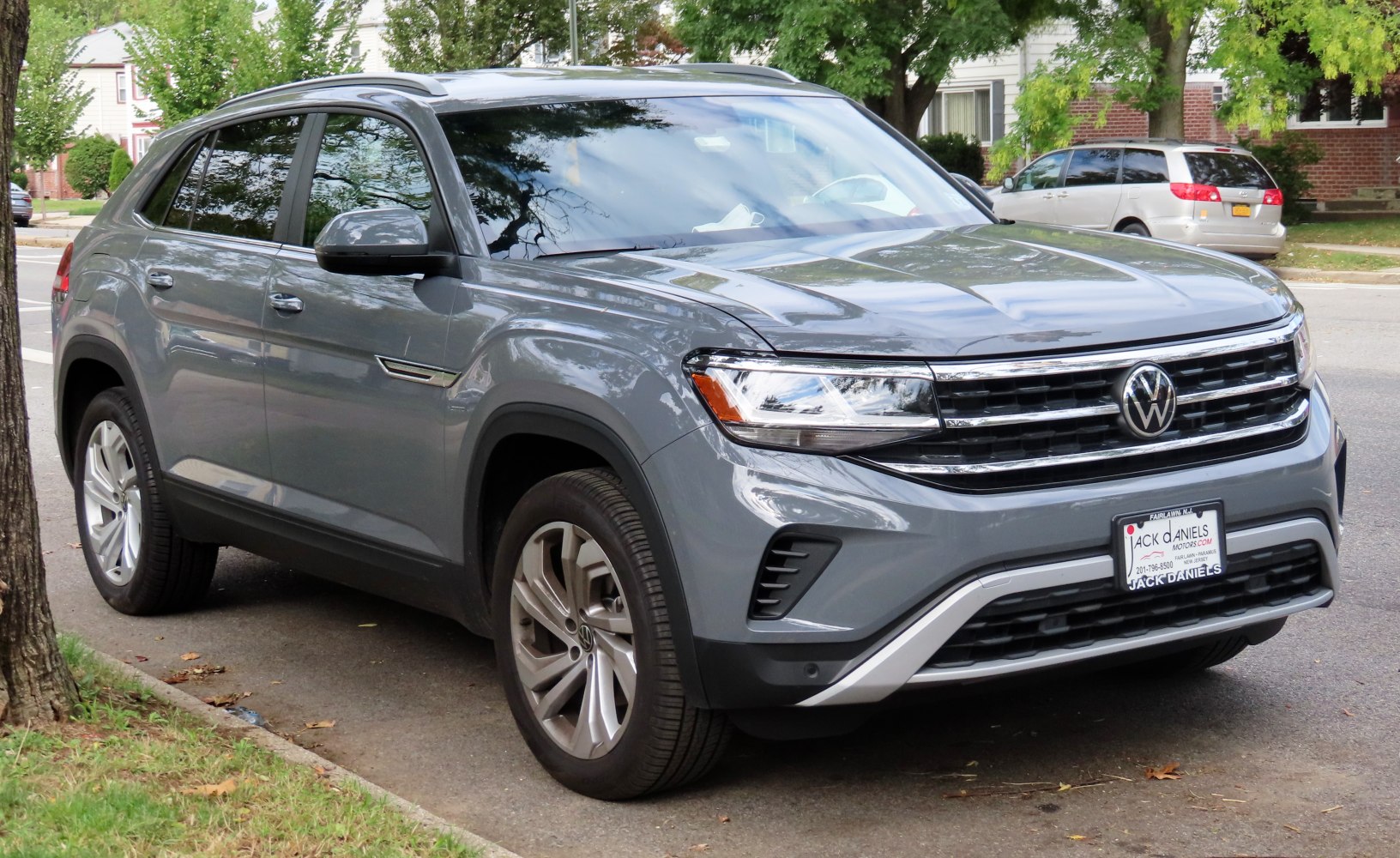 Front and side view of sport utility vehicle with sleek design and LED headlights.