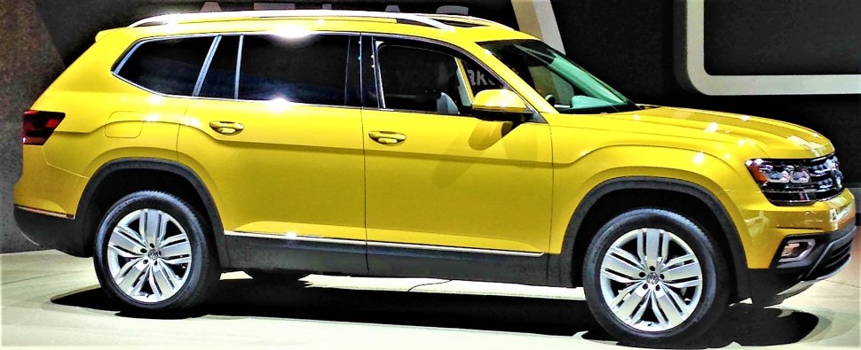 Yellow SUV side profile with alloy wheels and tinted windows