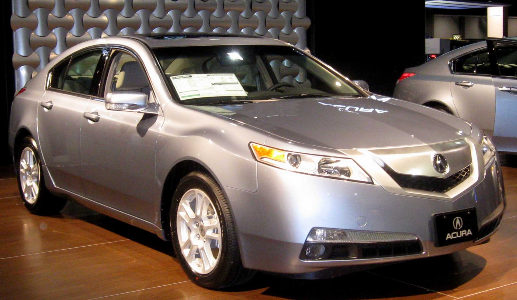 Luxury sedan front left side view with Acura grille and headlights